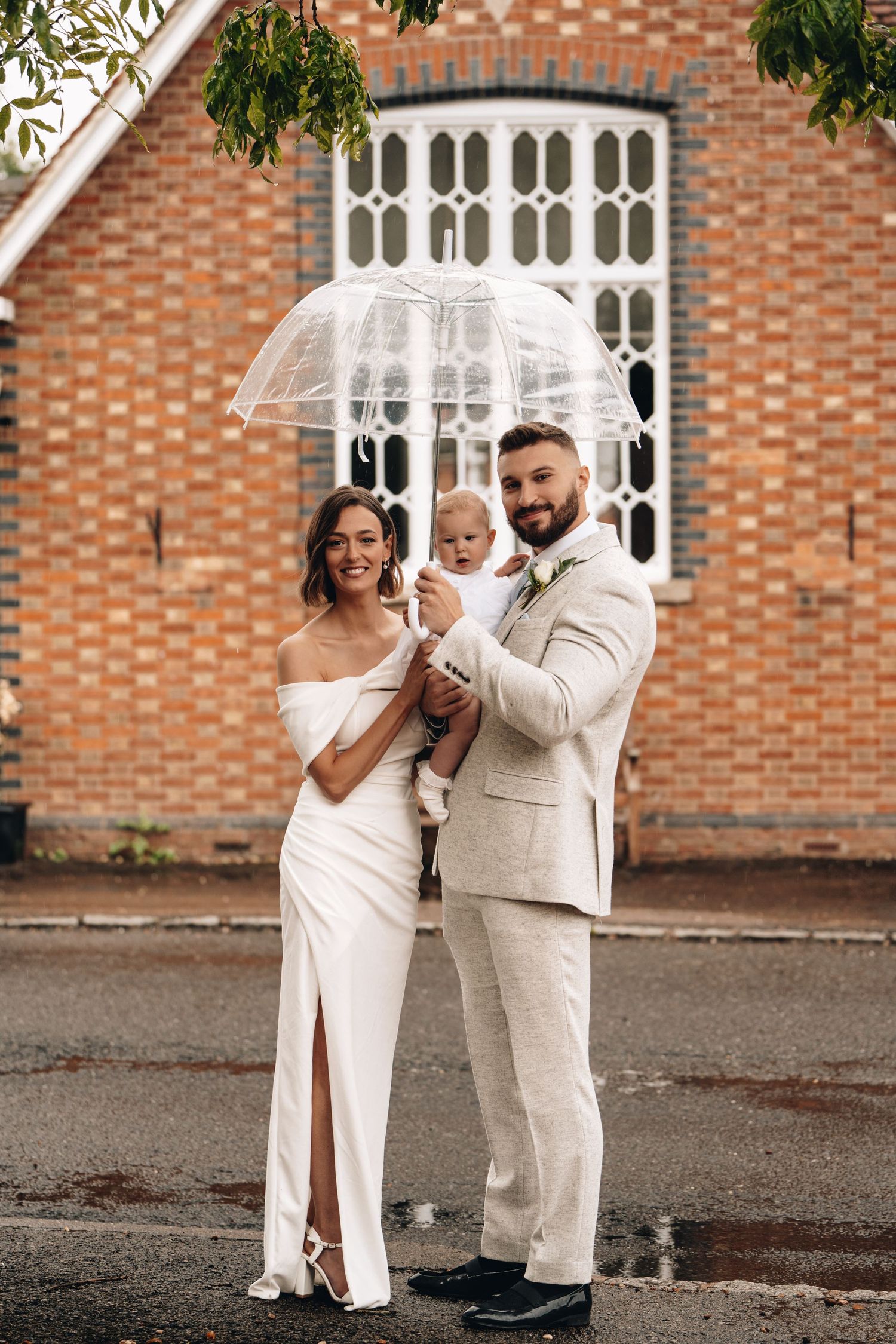 Milton Keynes EIVA Photography Wedding family picture with baby under umbrella rain
