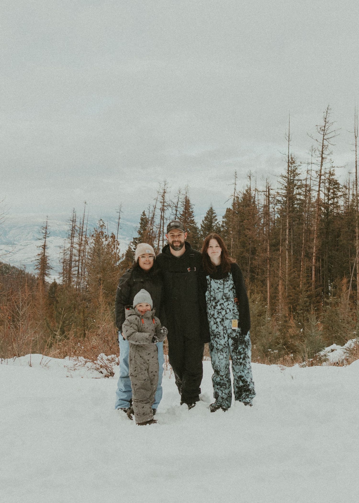 wedding photographer with her family in snowy bc mountains