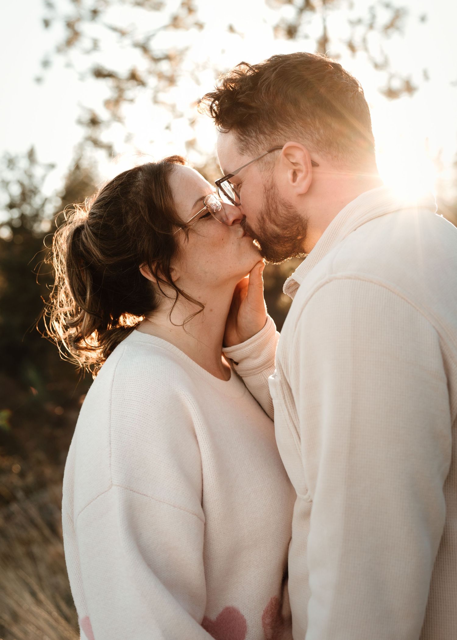 couple sharing a quiet kiss during west kelowna bc engagement session with gorgeous sunset in the background