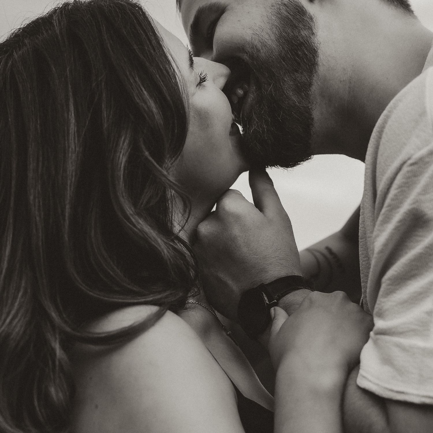 candid engagement photography capturing couple kissing in black and white photo in Vernon bc