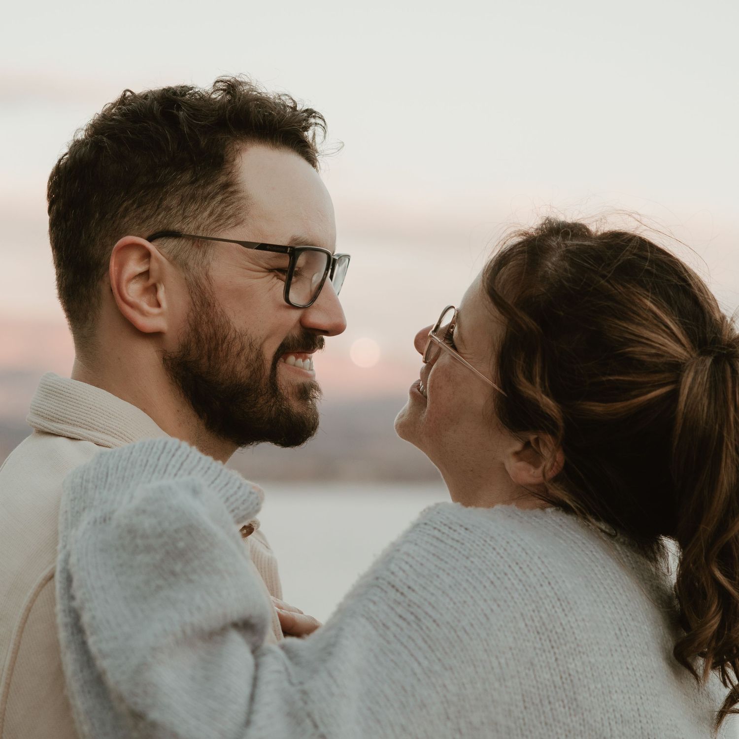 okanagan engagement photographer capturing smiling couple with okanagan lake in the background