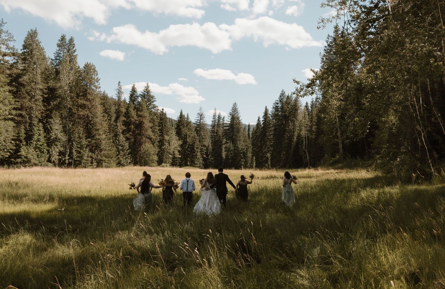 married couple running through tall grass in bc mountain wedding, in Joe Rich B.C. just outside of Kelowna B.C.