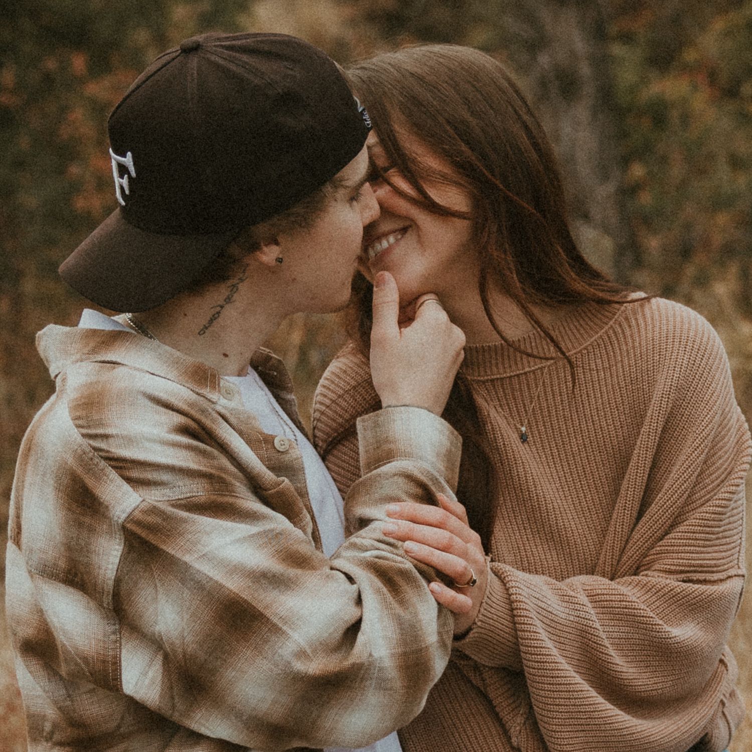 intimate couple photo of couple sharing a quiet moment and gentle kiss in okanagan field