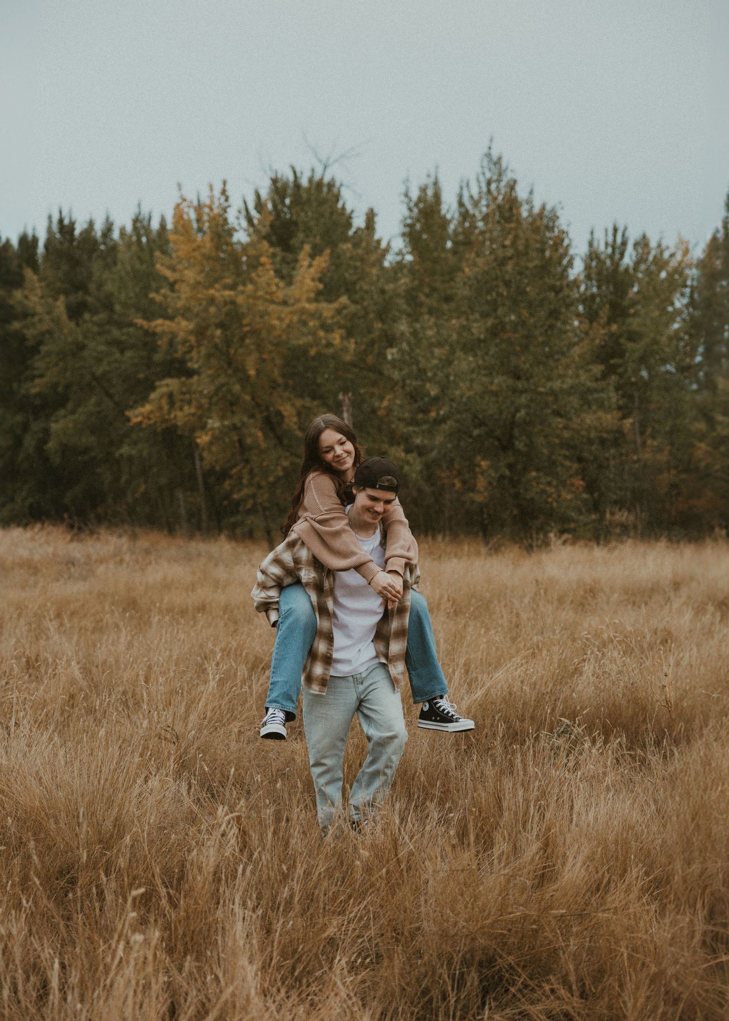 kelowna couple playing in a field