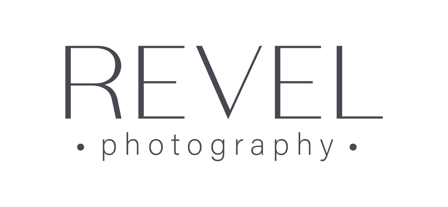 Minimalist logo design for Revel Photography in dark gray text on black background.