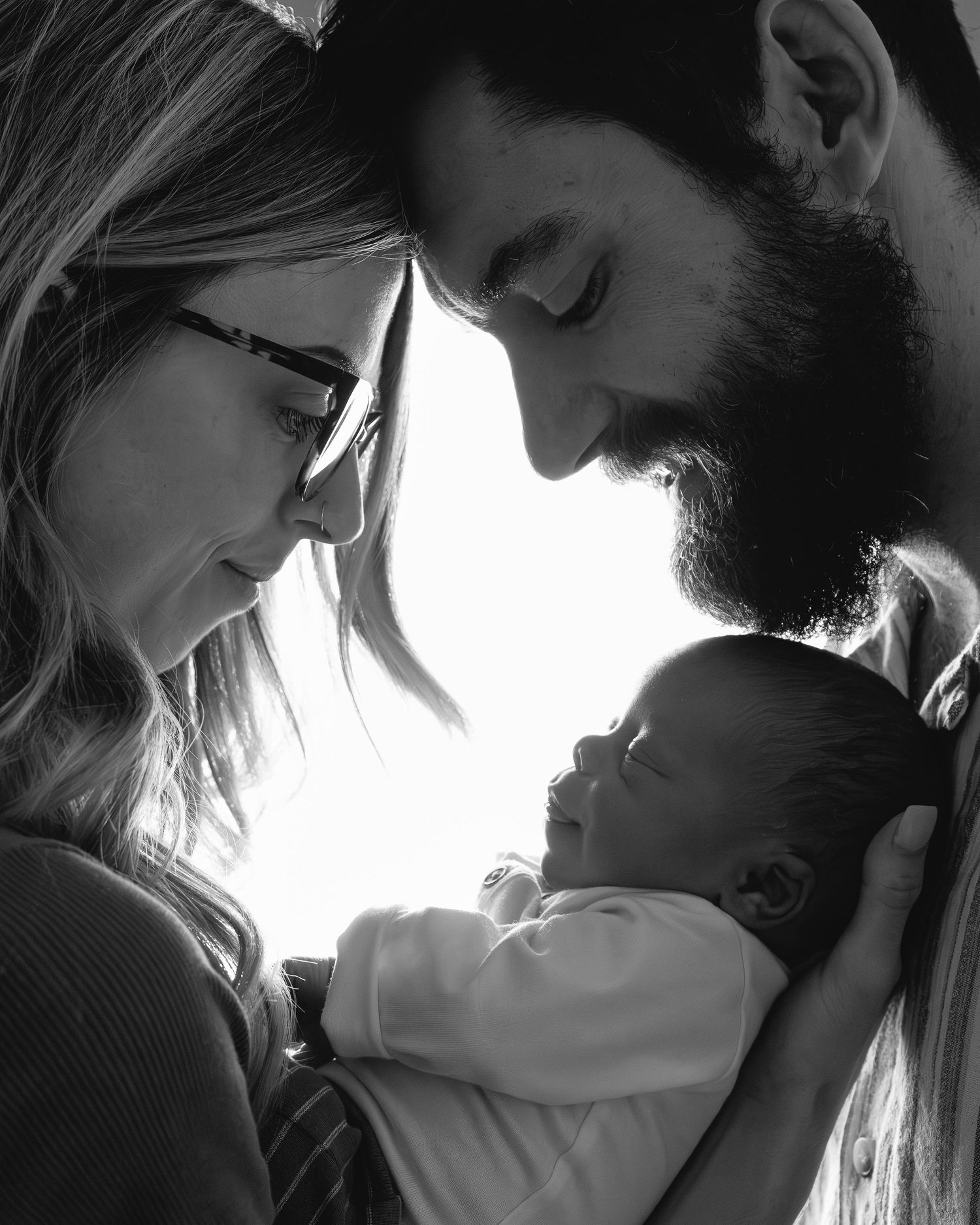 A series of romantic silhouetted intimate couple portraits conveying love and tenderness in black and white.