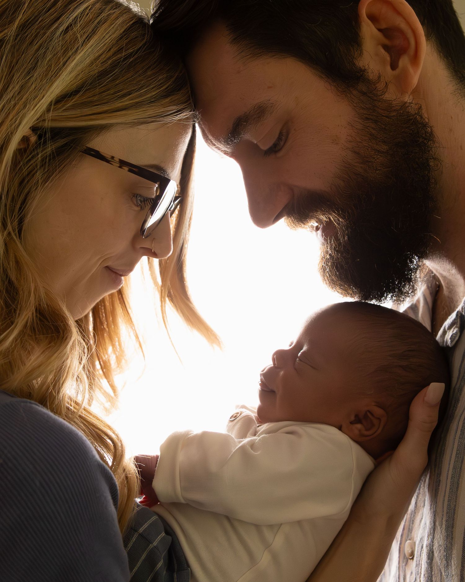A romantic sequence of intimate moments between a couple shown in silhouette against soft lighting.