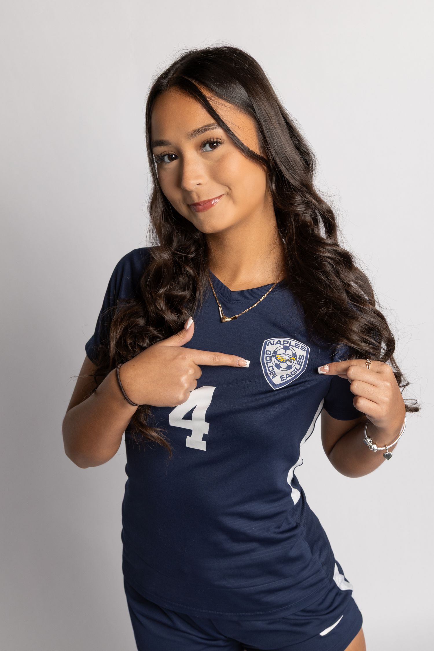 Person wearing navy blue sports jersey with number 4 poses in multiple angles against white background.