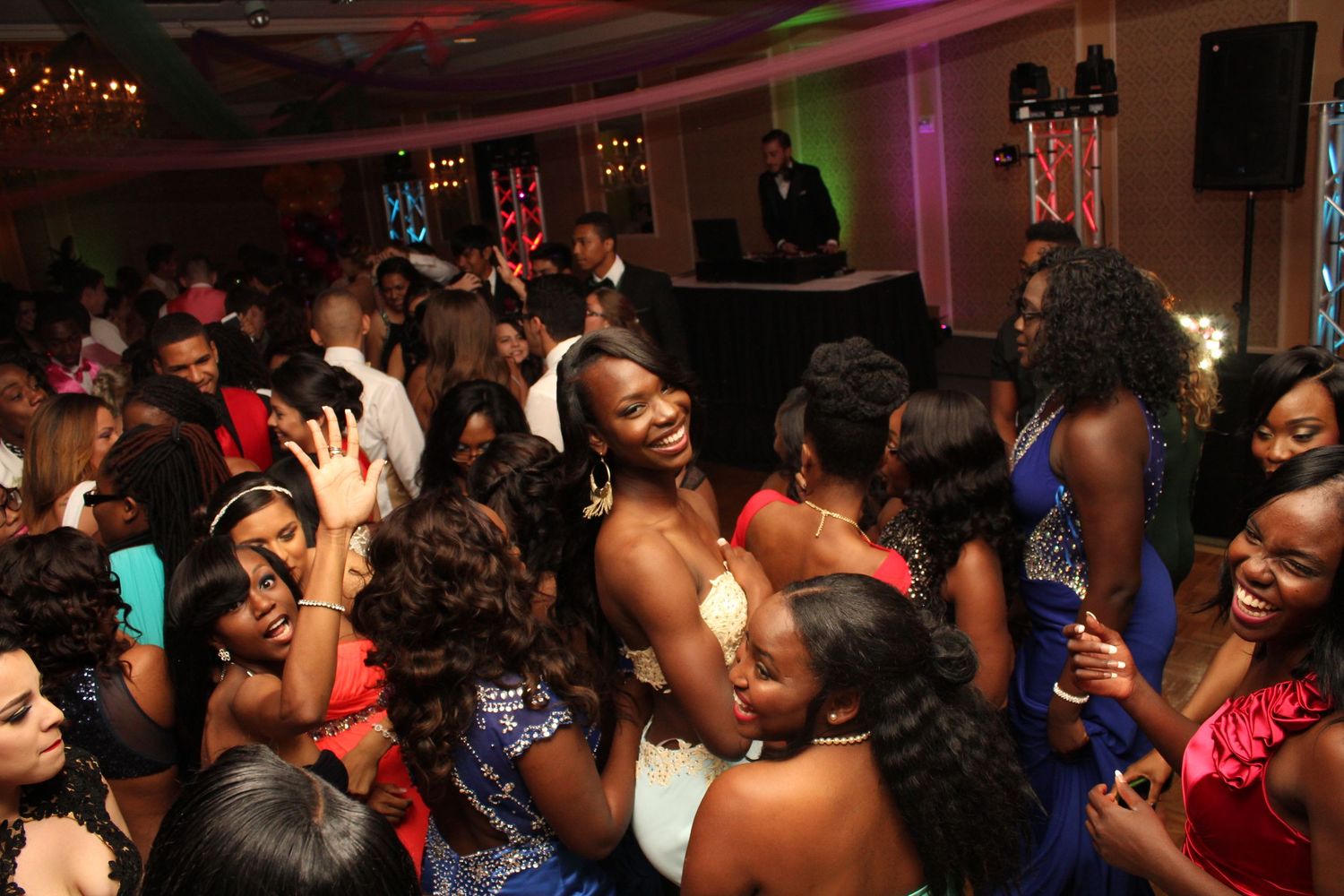 Crowded dance floor with people dancing and celebrating at a formal event.