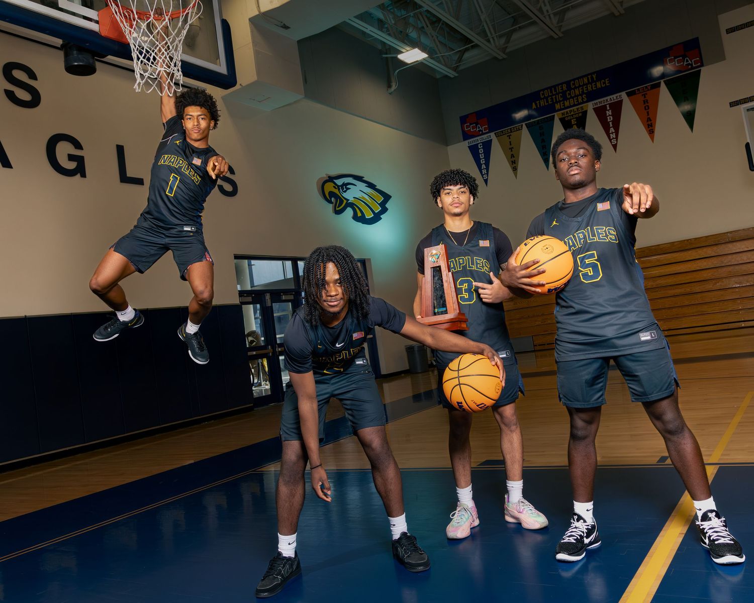 Basketball players demonstrate dynamic dribbling techniques and moves in a gymnasium during practice session.