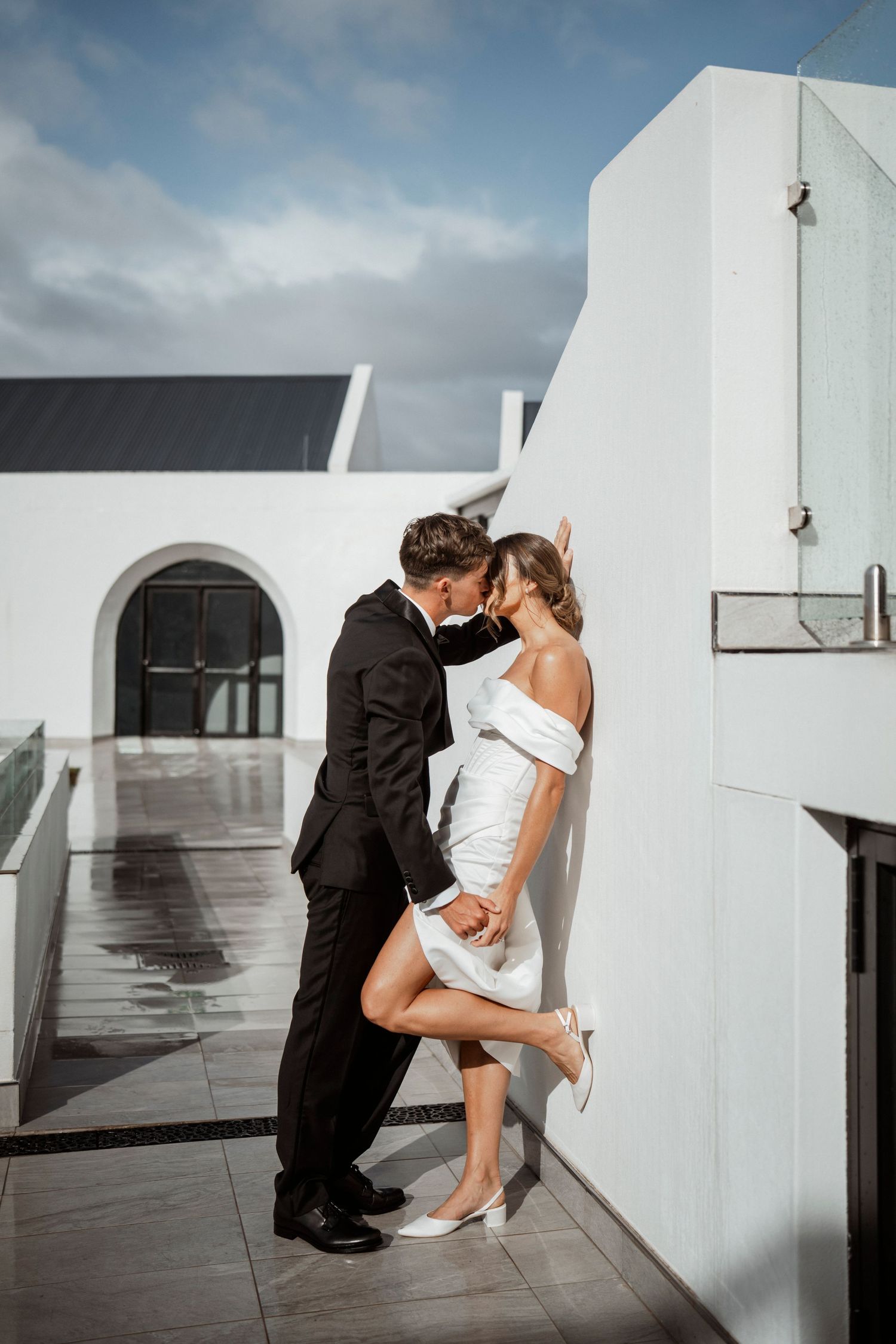 Couple in formal wedding attire share an intimate moment at Hazendal wedding venue.