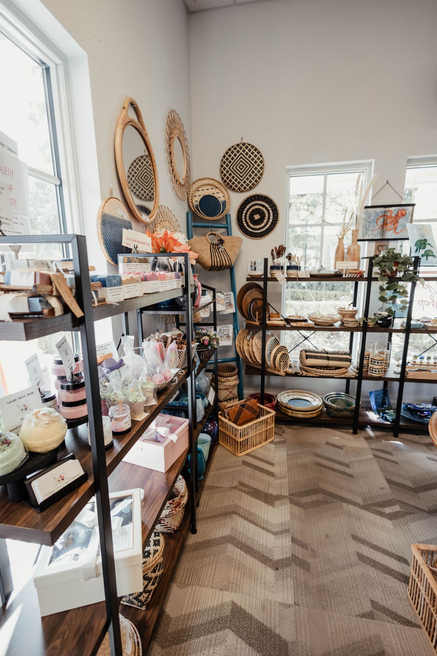 Interior of boutique showing shelves of home decor items with woven baskets and geometric wall art.