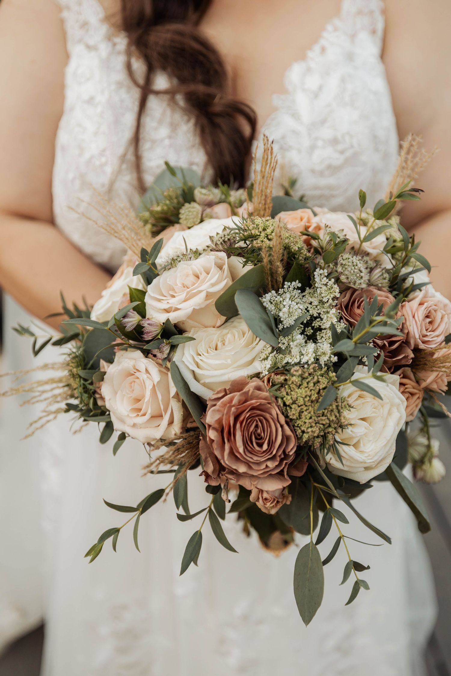 Elegant bridal bouquet featuring blush roses, white flowers, and eucalyptus greenery.