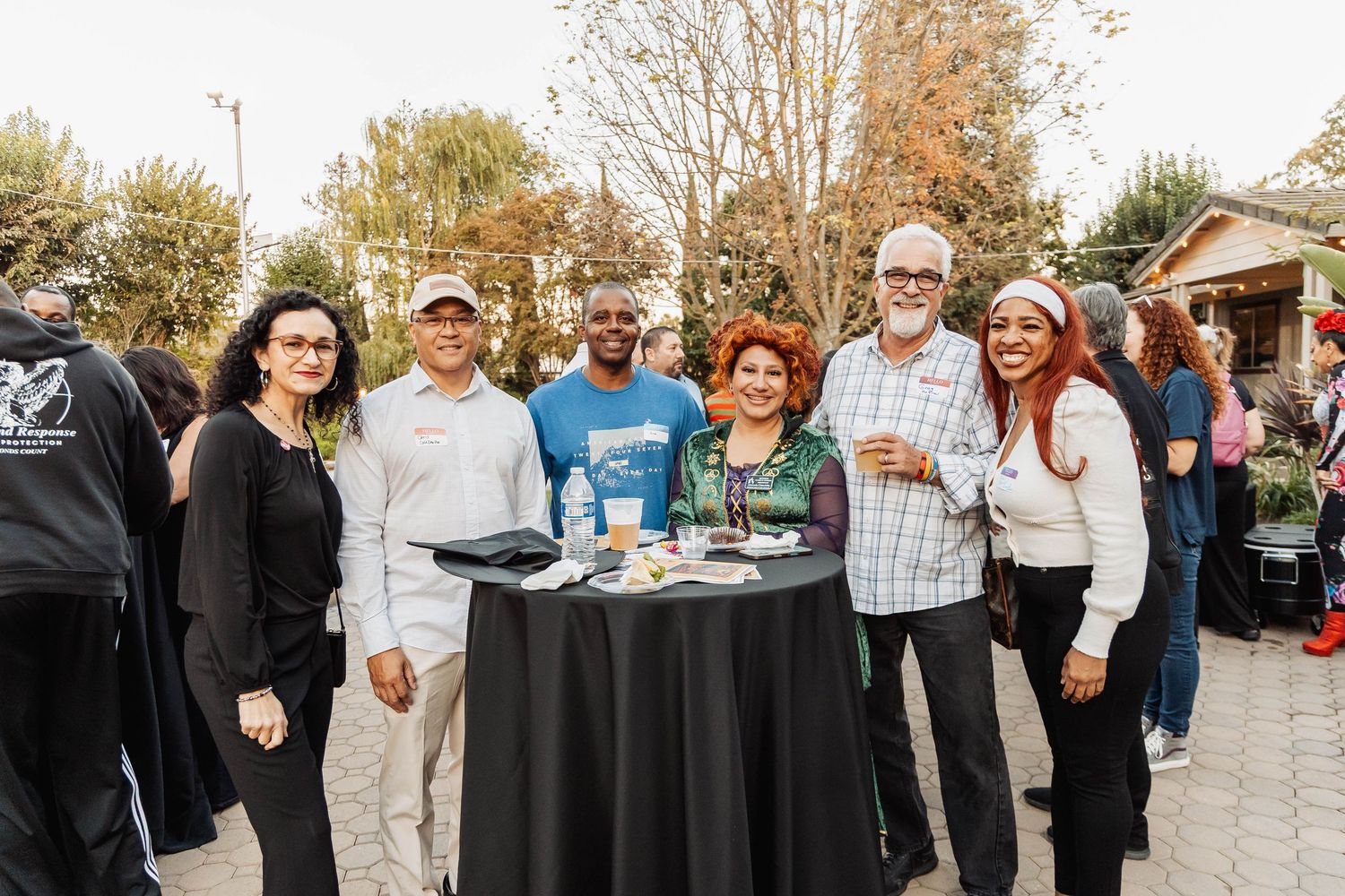 Guests mingle and socialize at an outdoor gathering event.