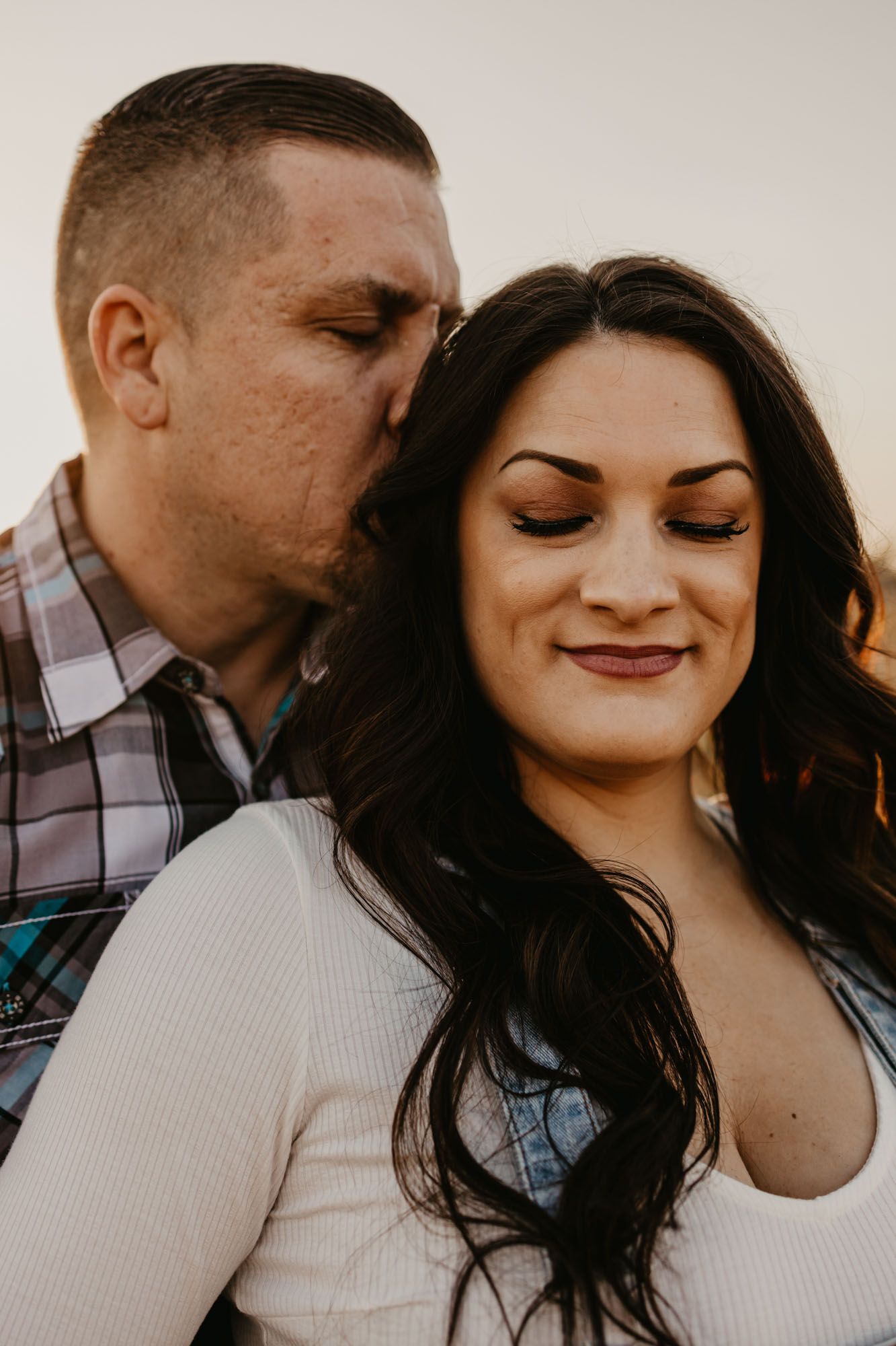 An intimate portrait of a couple during their engagement session with soft lighting.