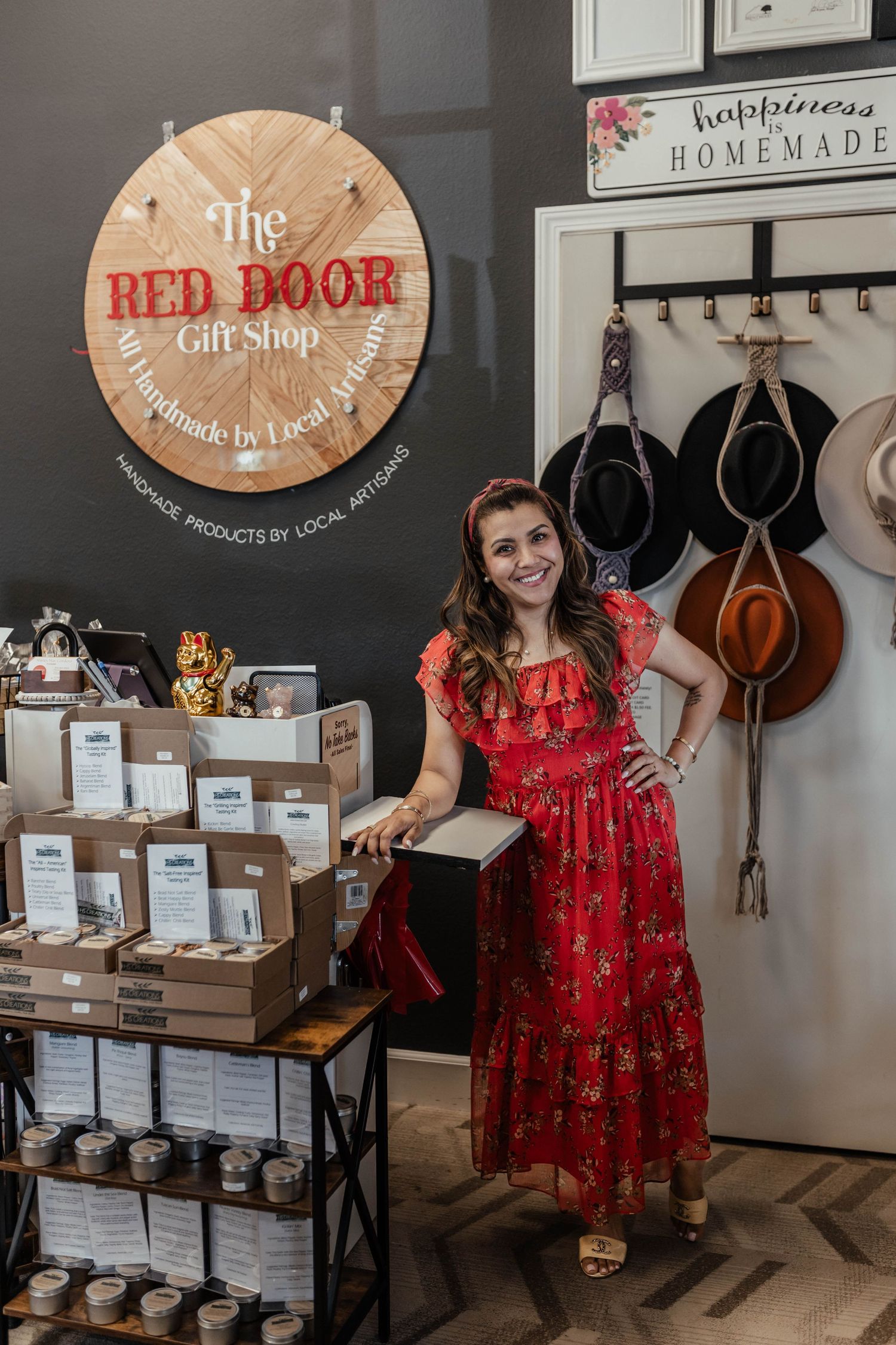 Interior view of The Red Door Gift Shop with rustic wooden sign and retail display shelves.