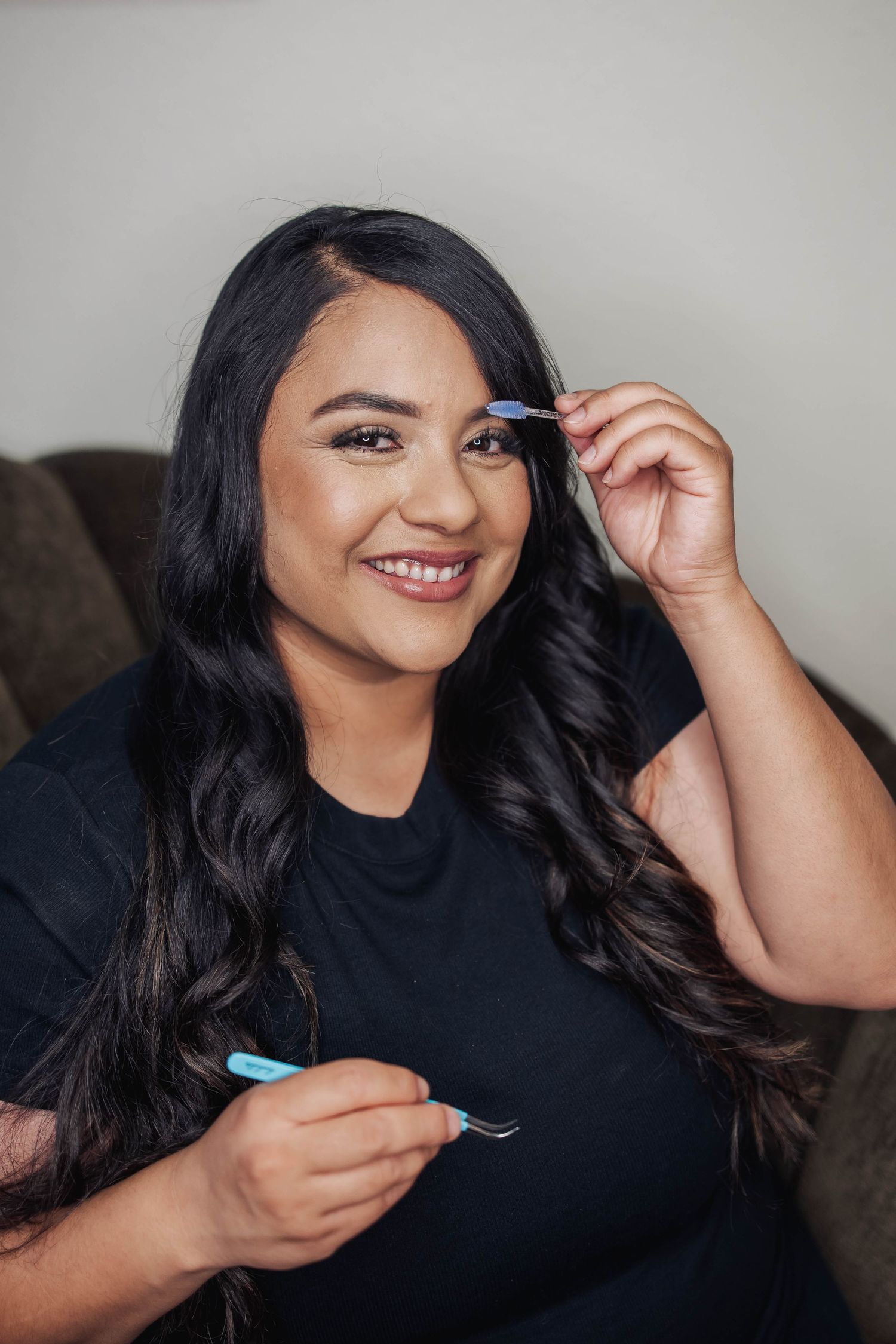 Person in black shirt demonstrating beauty product application.