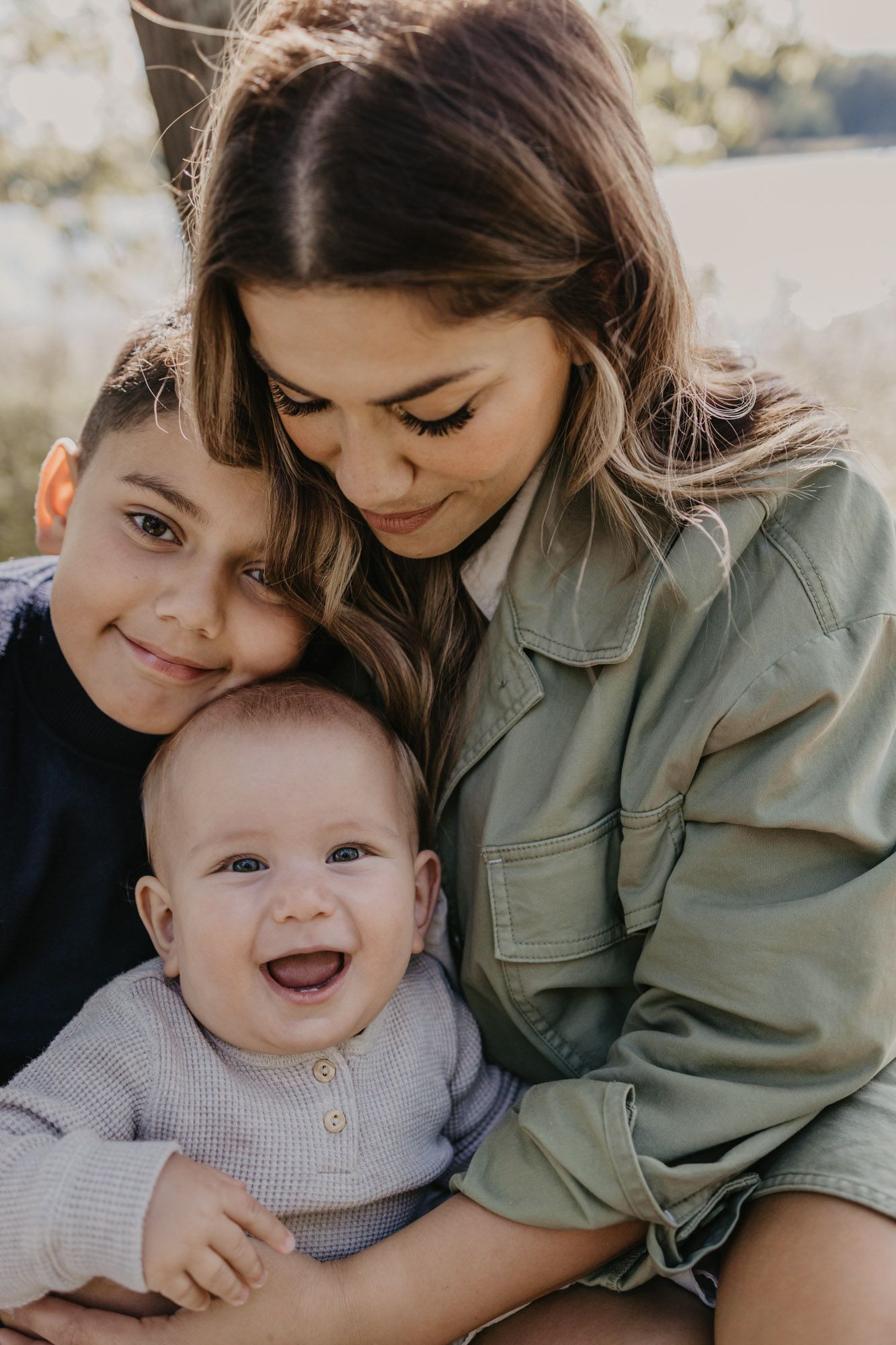Candid family moment showing joyful expressions during outdoor photo session.