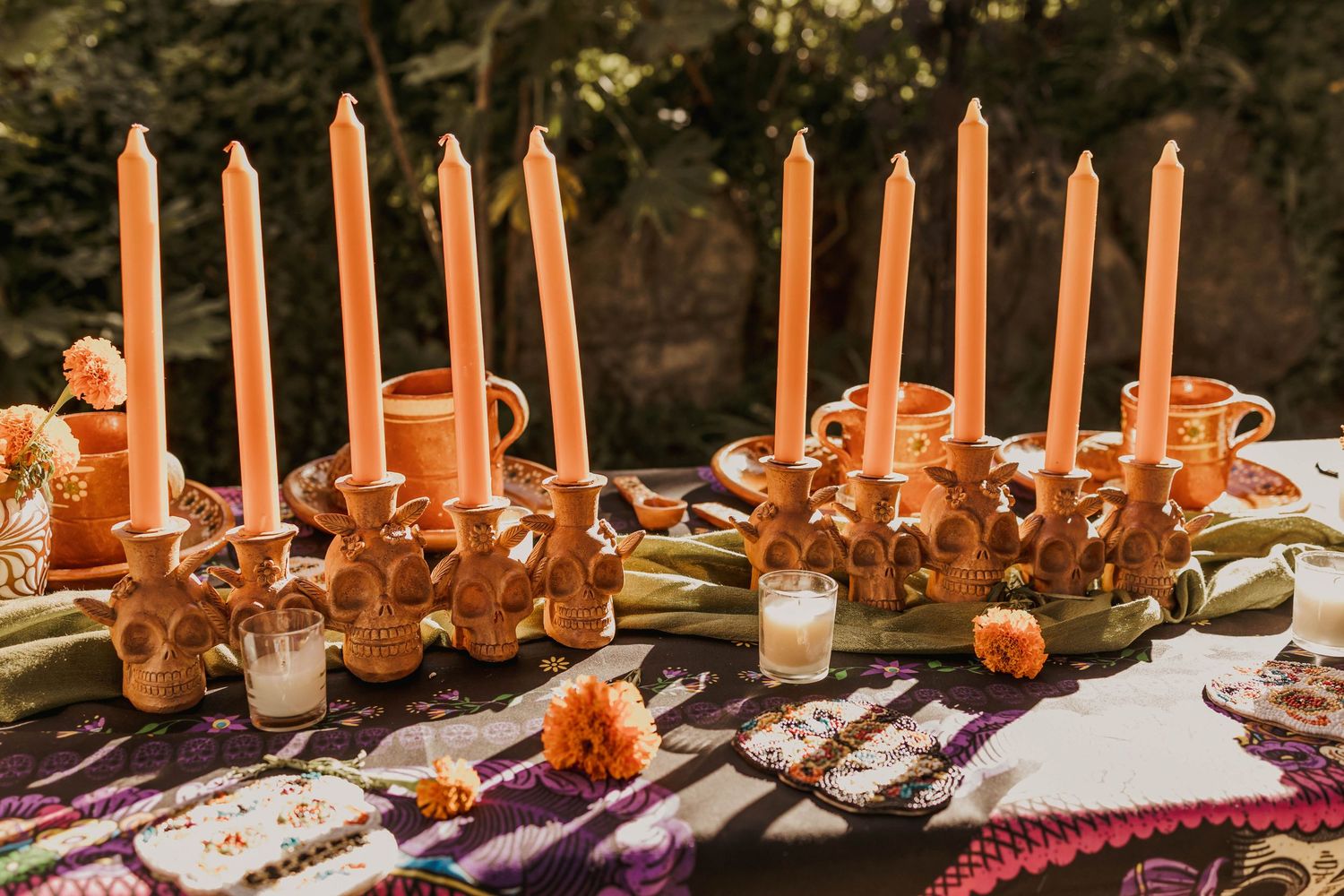 Row of orange candles arranged for Day of the Dead celebration.