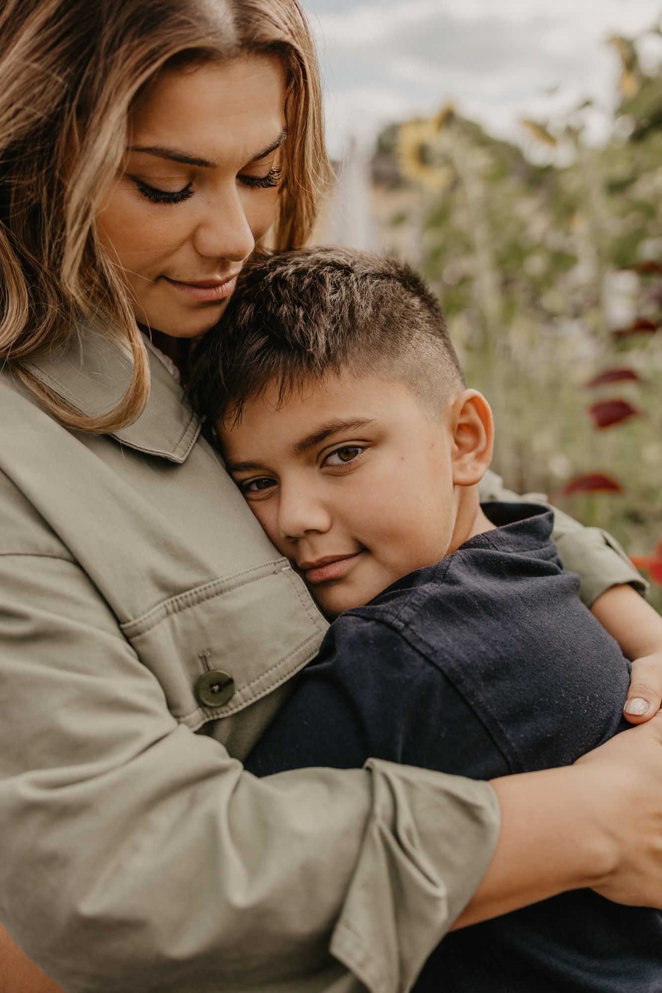A tender embrace captured against a backdrop of sunflowers.