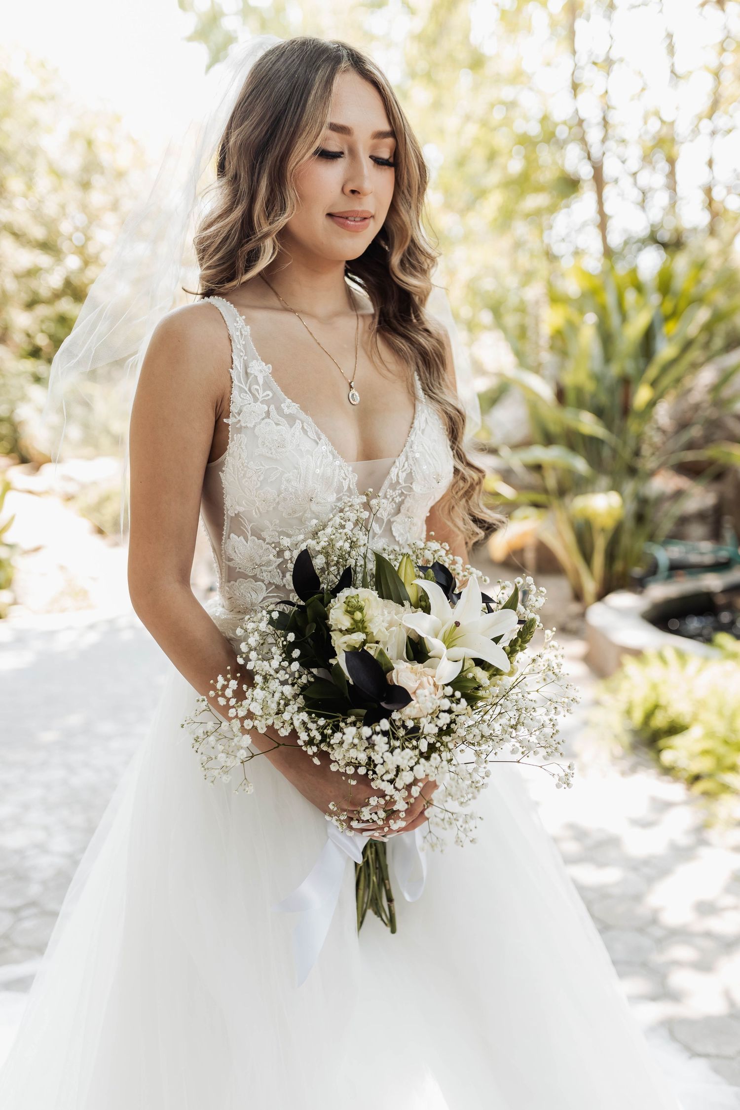 Close-up shots of an elegant white bridal bouquet with lilies and baby's breath against a light background.