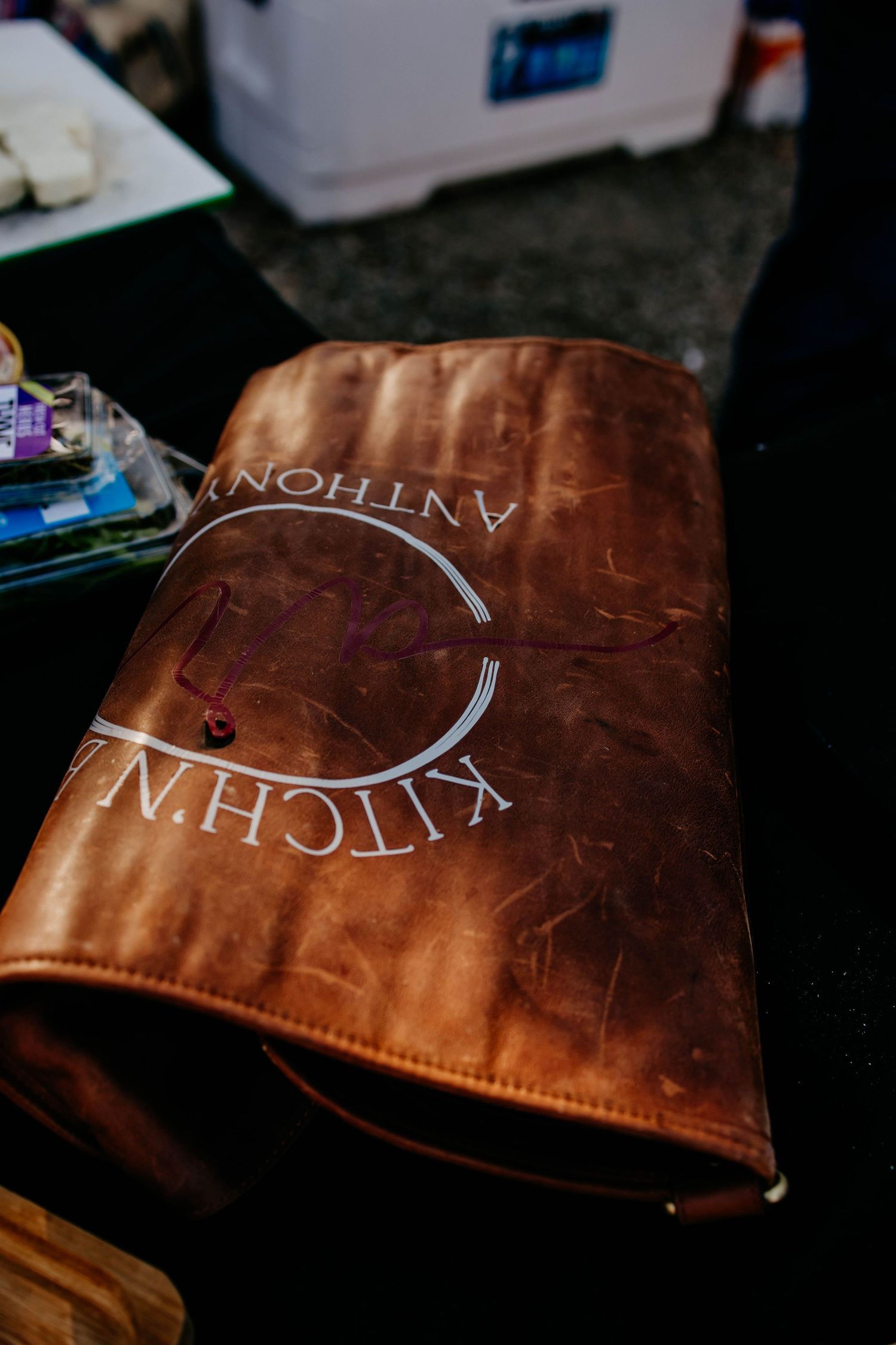 Brown leather menu cover with embossed text in elegant lettering.