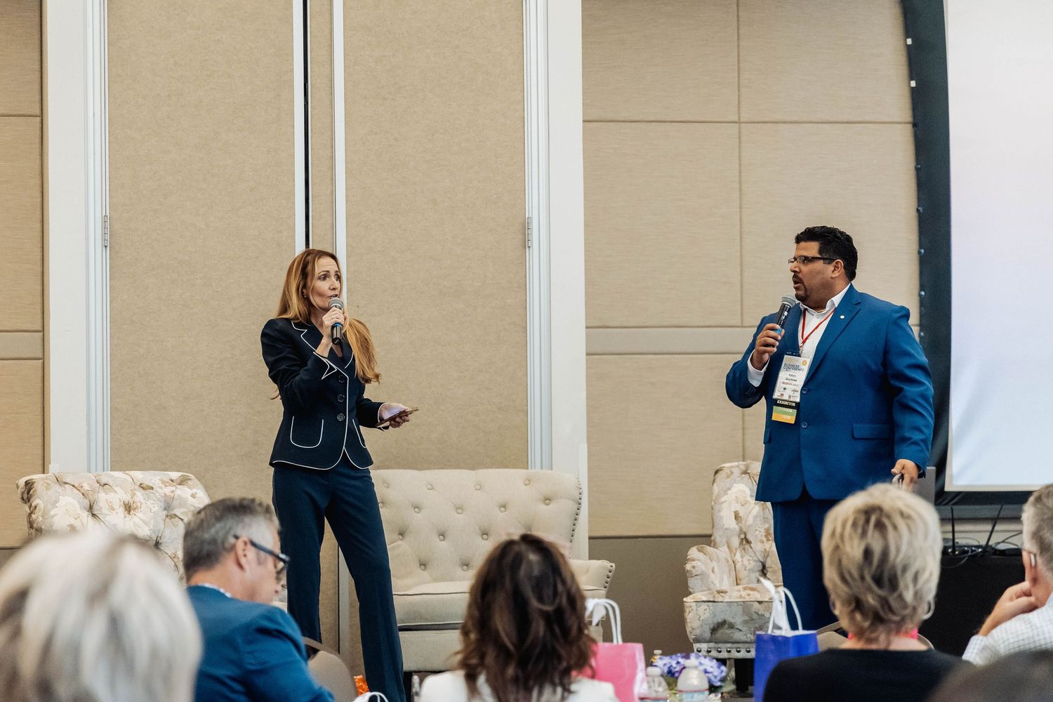 Presenters speaking to audience during professional conference session.