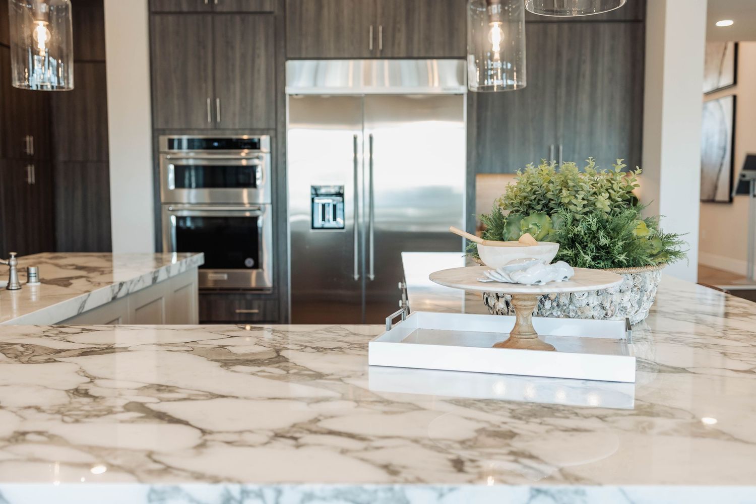 Luxurious marble countertop and modern kitchen design with wood cabinets.