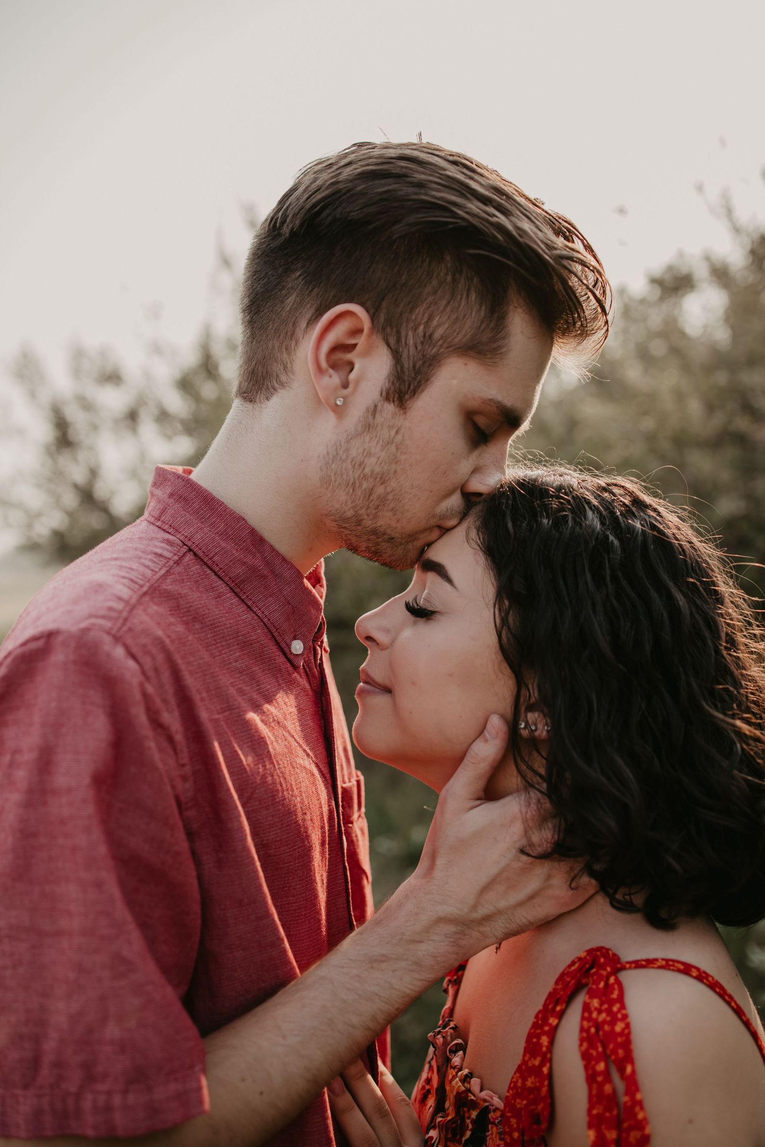 A romantic sunset portrait session showing tender moments between a couple.
