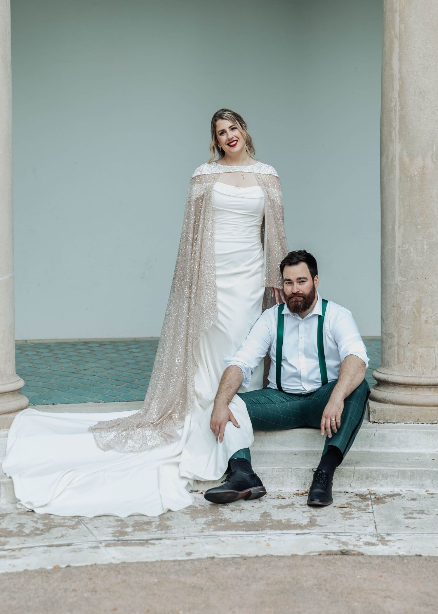 Artistic wedding portrait series with couple sitting by columns.