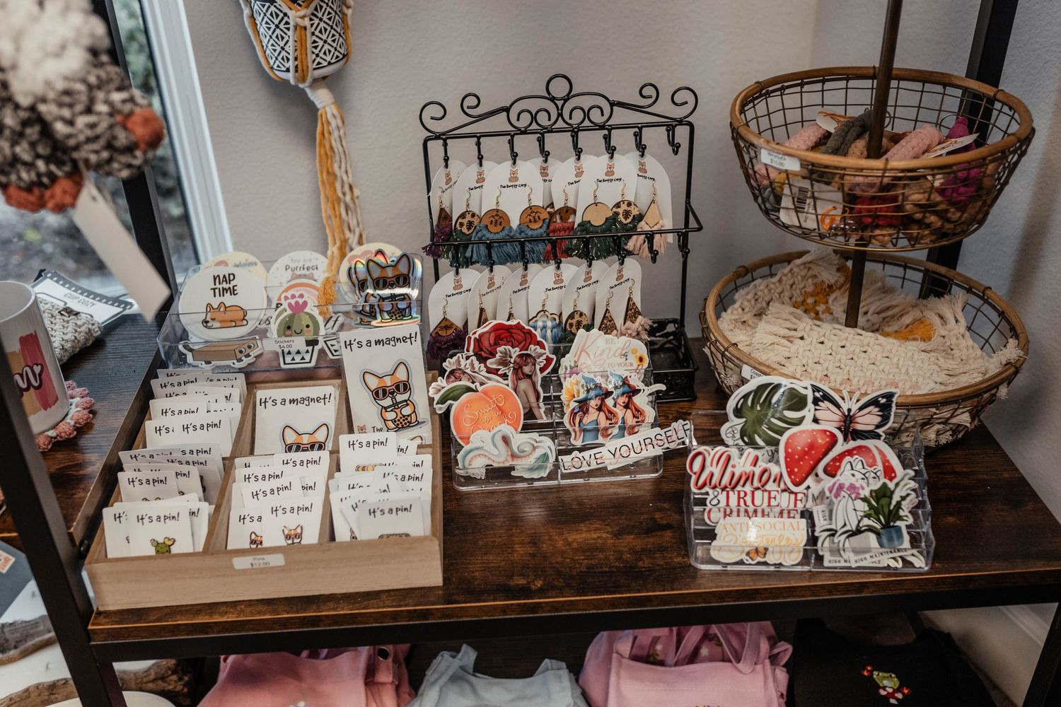 Rustic wooden retail display featuring stationery items and decorative merchandise.