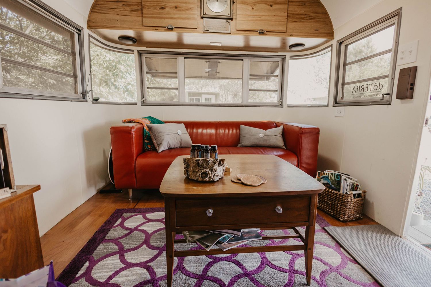 Interior view of a cozy room with red cushions and wooden ceiling.