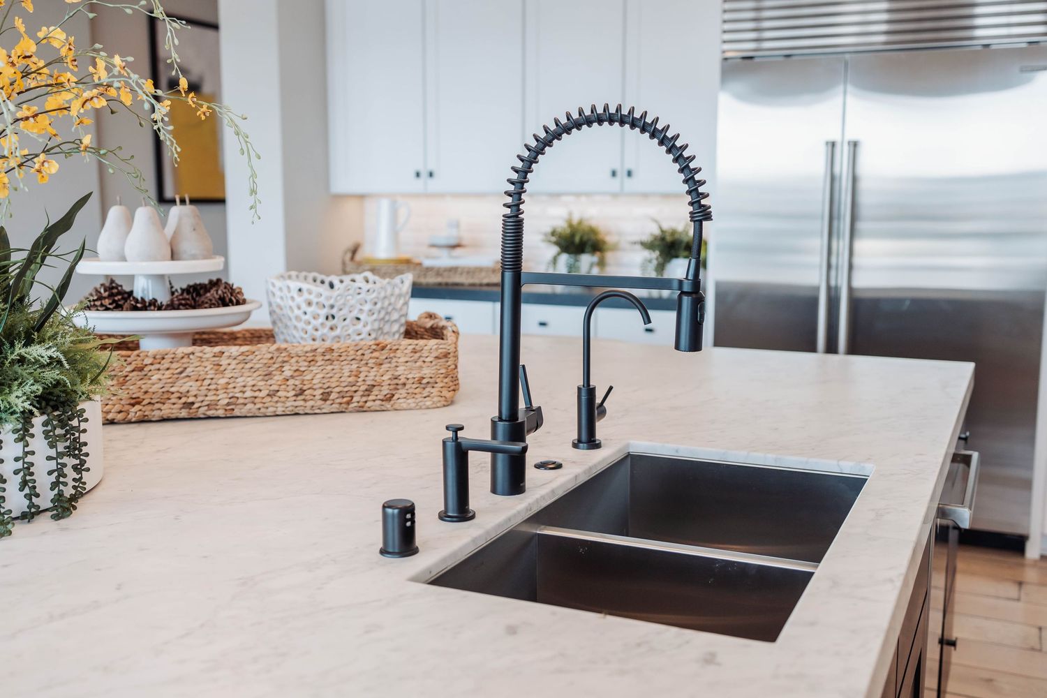 Contemporary kitchen with farmhouse sink, white subway tile backsplash and stainless steel appliances.