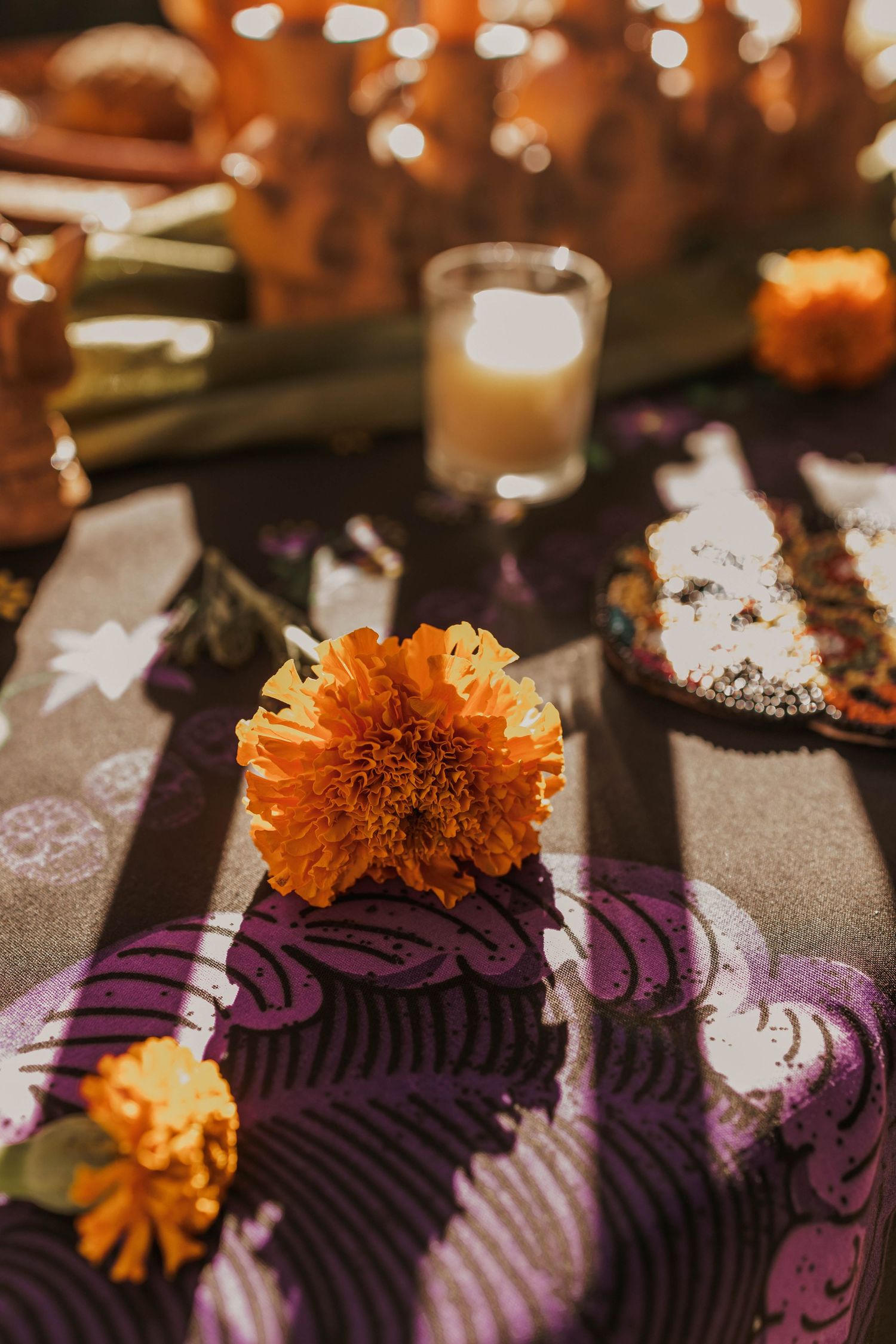Purple and orange Day of the Dead altar decorations with marigold flowers.