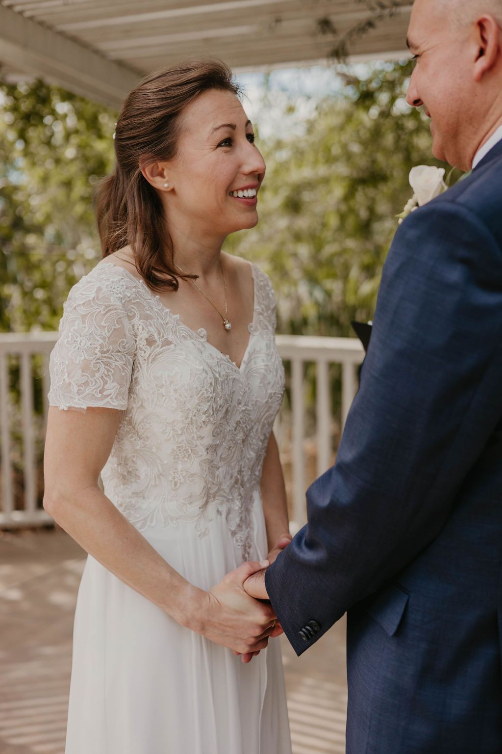 A candid moment of joy shared between a couple during their outdoor wedding ceremony.
