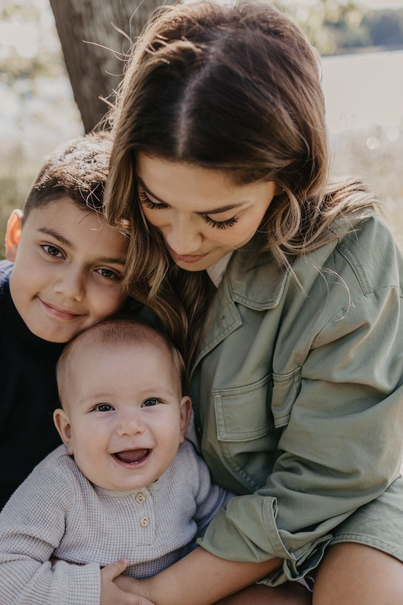 Sweet candid moment of family bonding during outdoor photo session.
