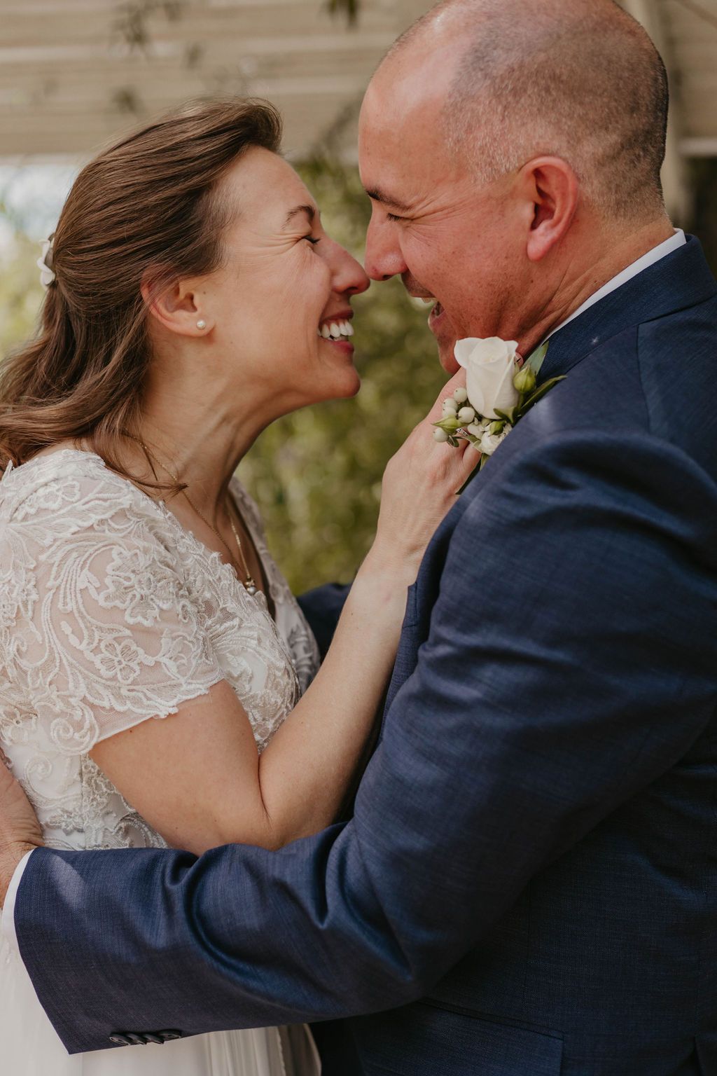 Intimate moment between newlyweds sharing laughter after their ceremony.