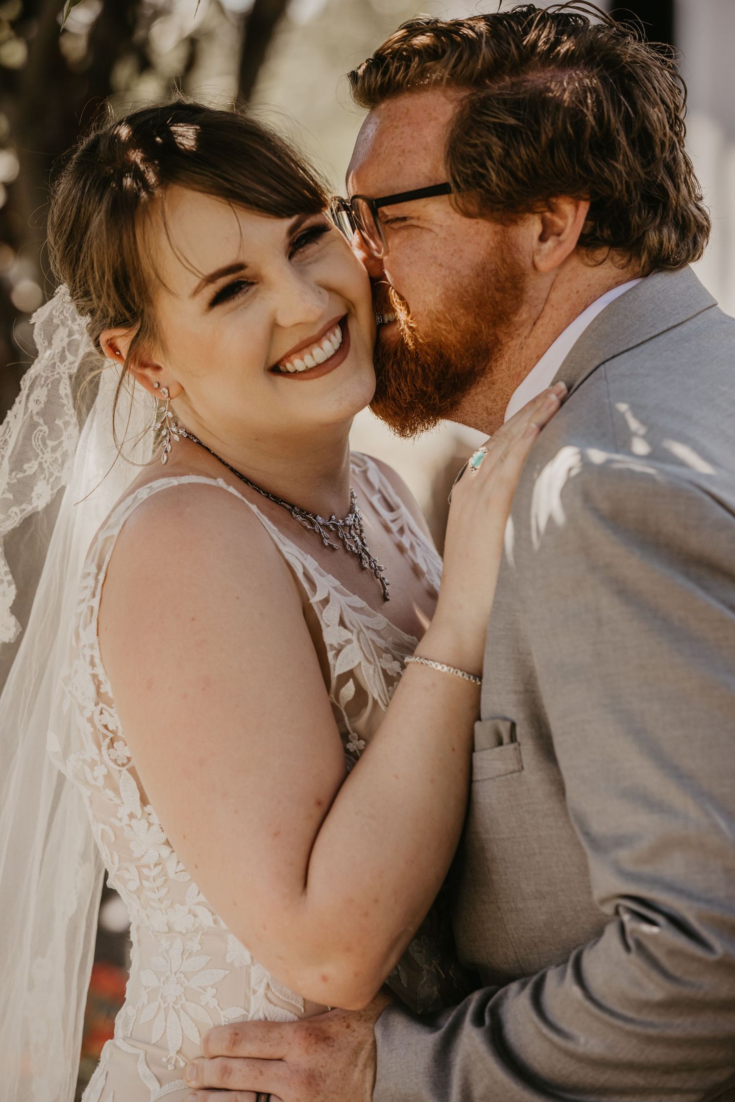Intimate wedding portrait showing tender moment between newlyweds in natural light.