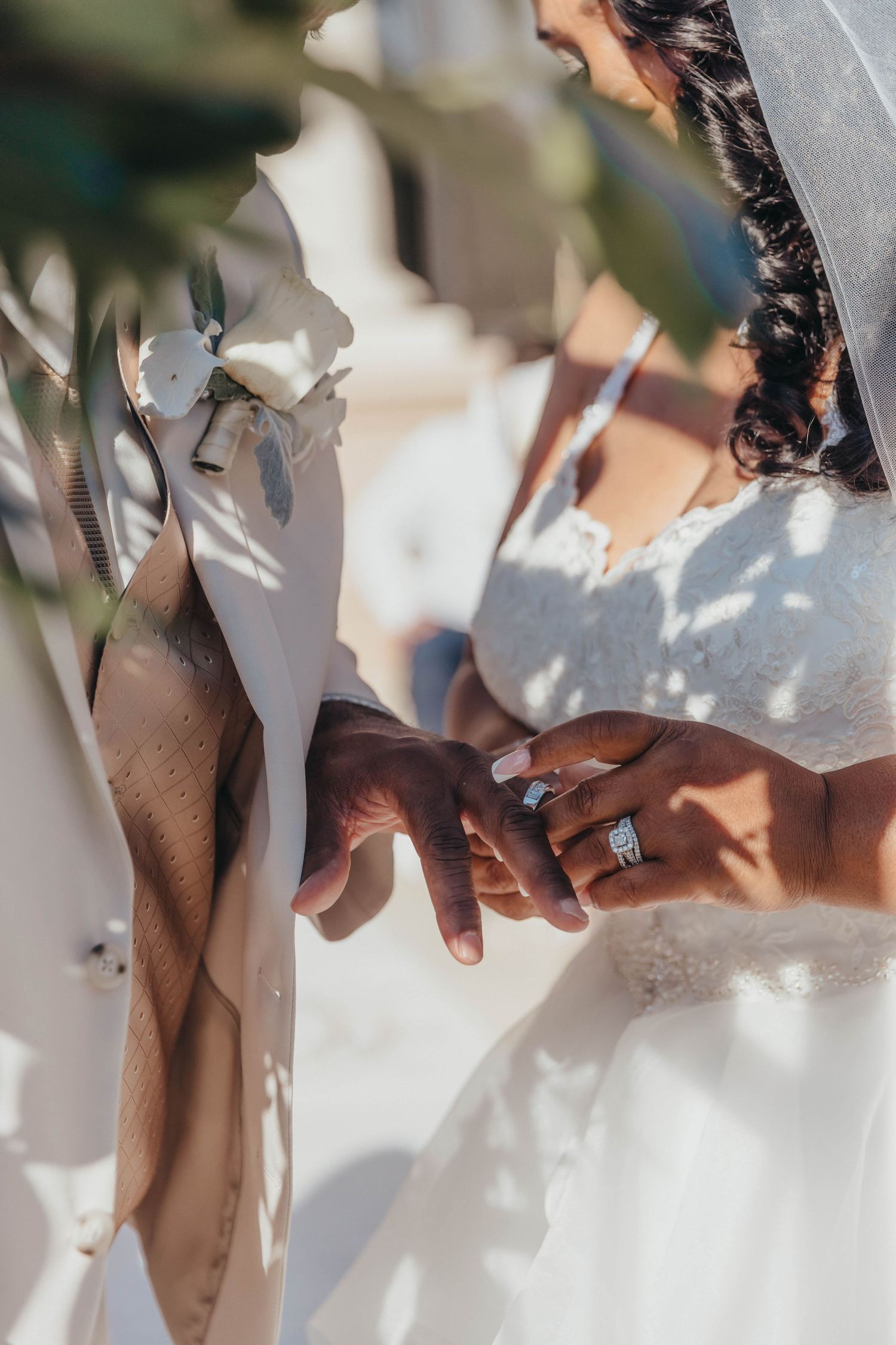 Close-up of hands holding during an outdoor wedding ceremony.