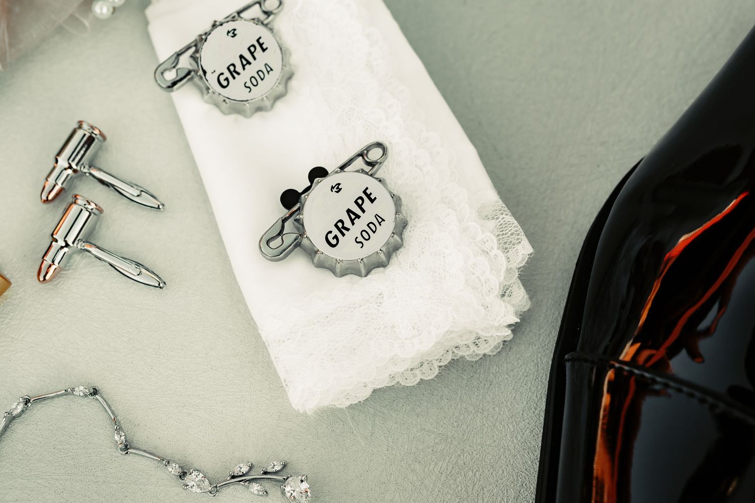 Vintage style key pendants and torn paper tags arranged on a dark surface with dramatic lighting.