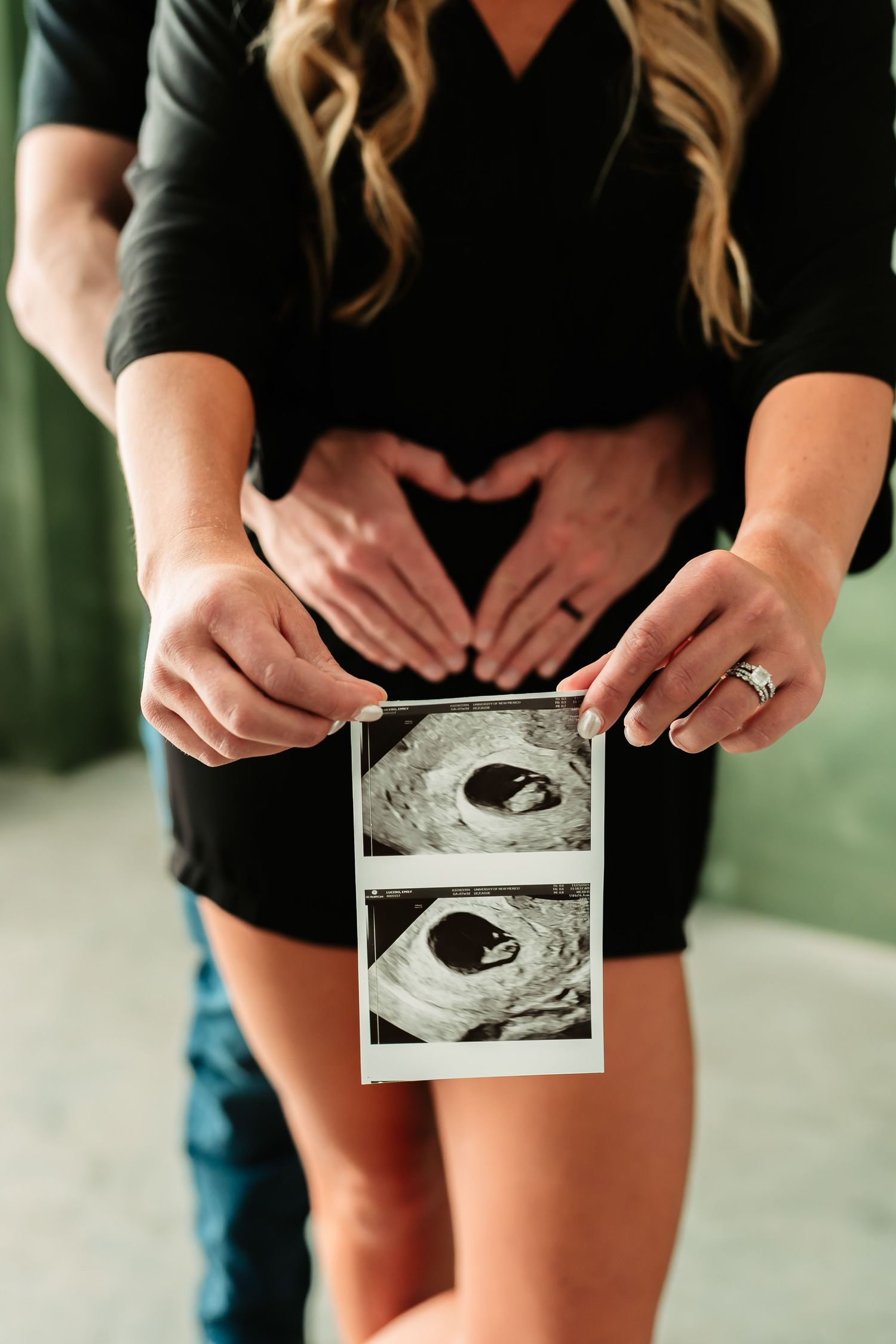 A series of ultrasound photos held in hands against a black dress background shows a pregnancy announcement sequence.