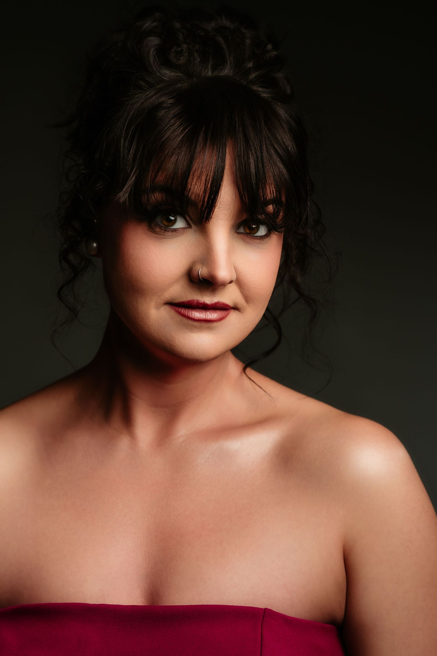 Portrait series showing a dramatic close-up with dark hair and red lipstick against a shadowy background.