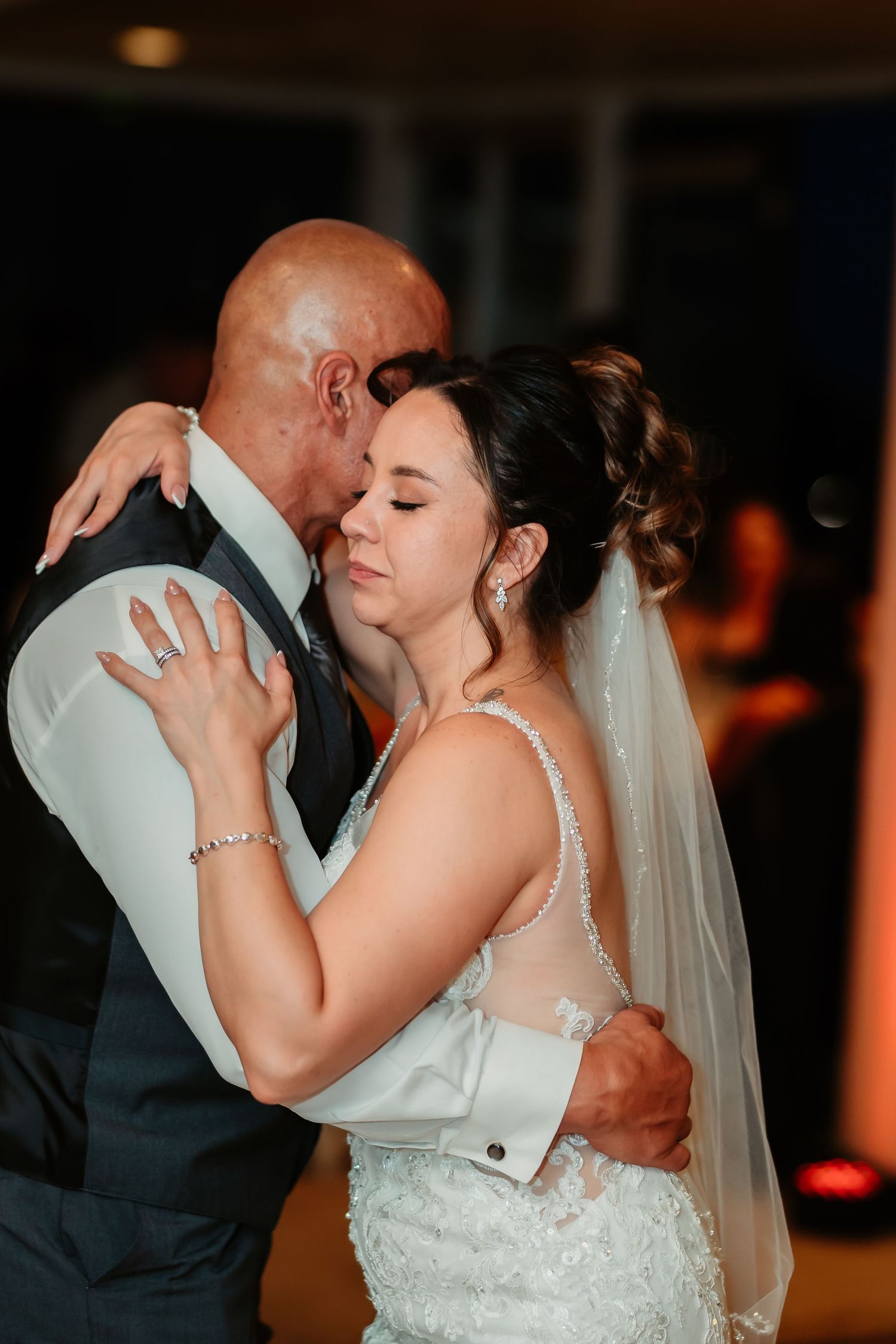 Romantic first dance between newlyweds at their wedding reception.