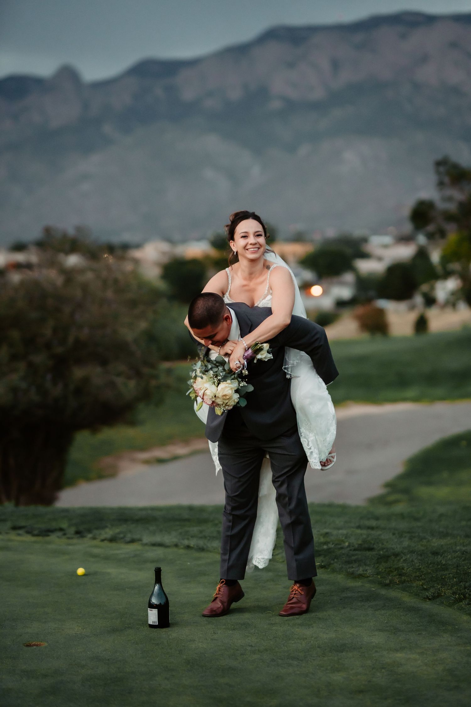 Fun wedding photoshoot with creative poses on a scenic golf course.