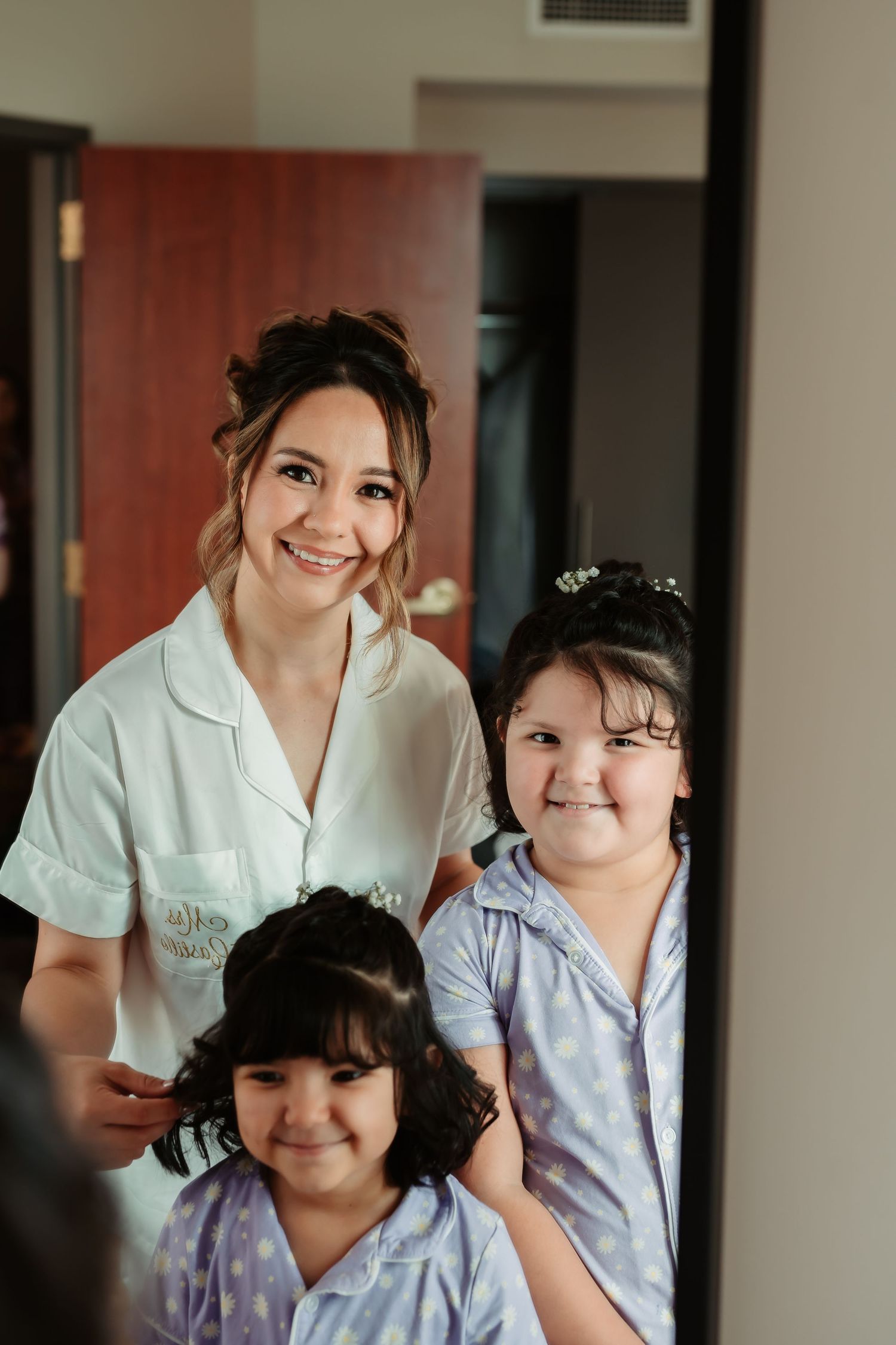 Healthcare professionals in white uniforms sharing warm smiles and caring moments during a medical shift.