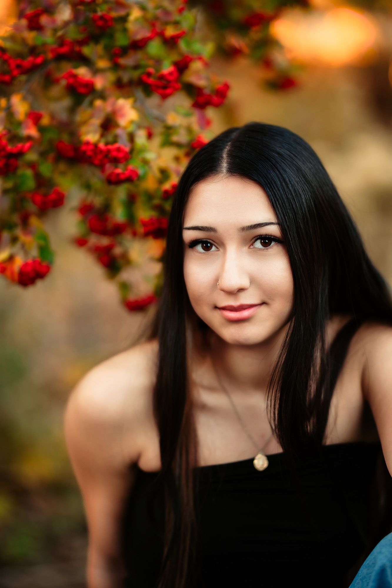 A series of portrait photos in an autumn setting with red berries and bokeh lighting creating a warm, artistic atmosphere.