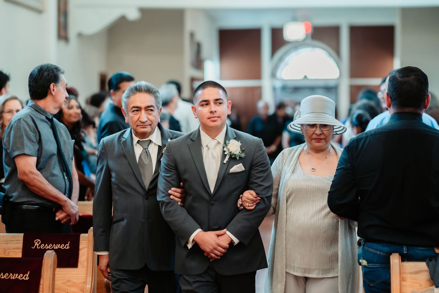 People socializing in formal attire at what appears to be a church or community gathering.