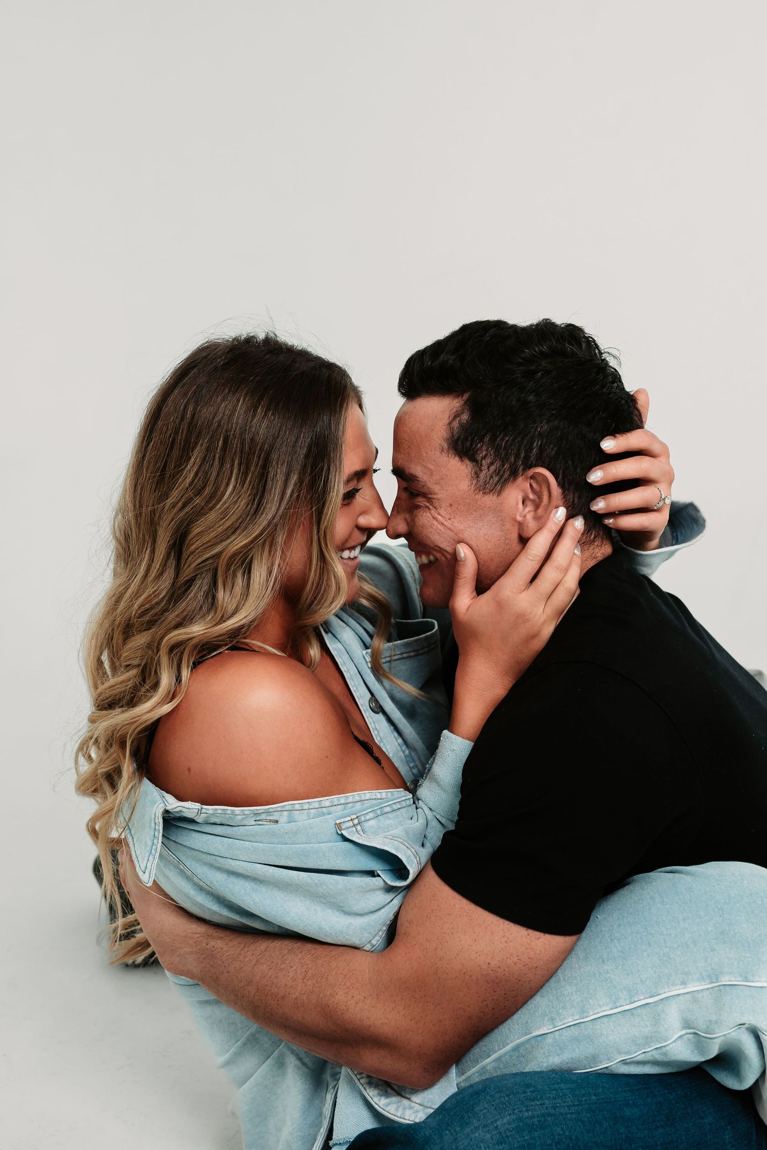 A romantic couple embraces and shares intimate moments in a series of casual denim outfits.