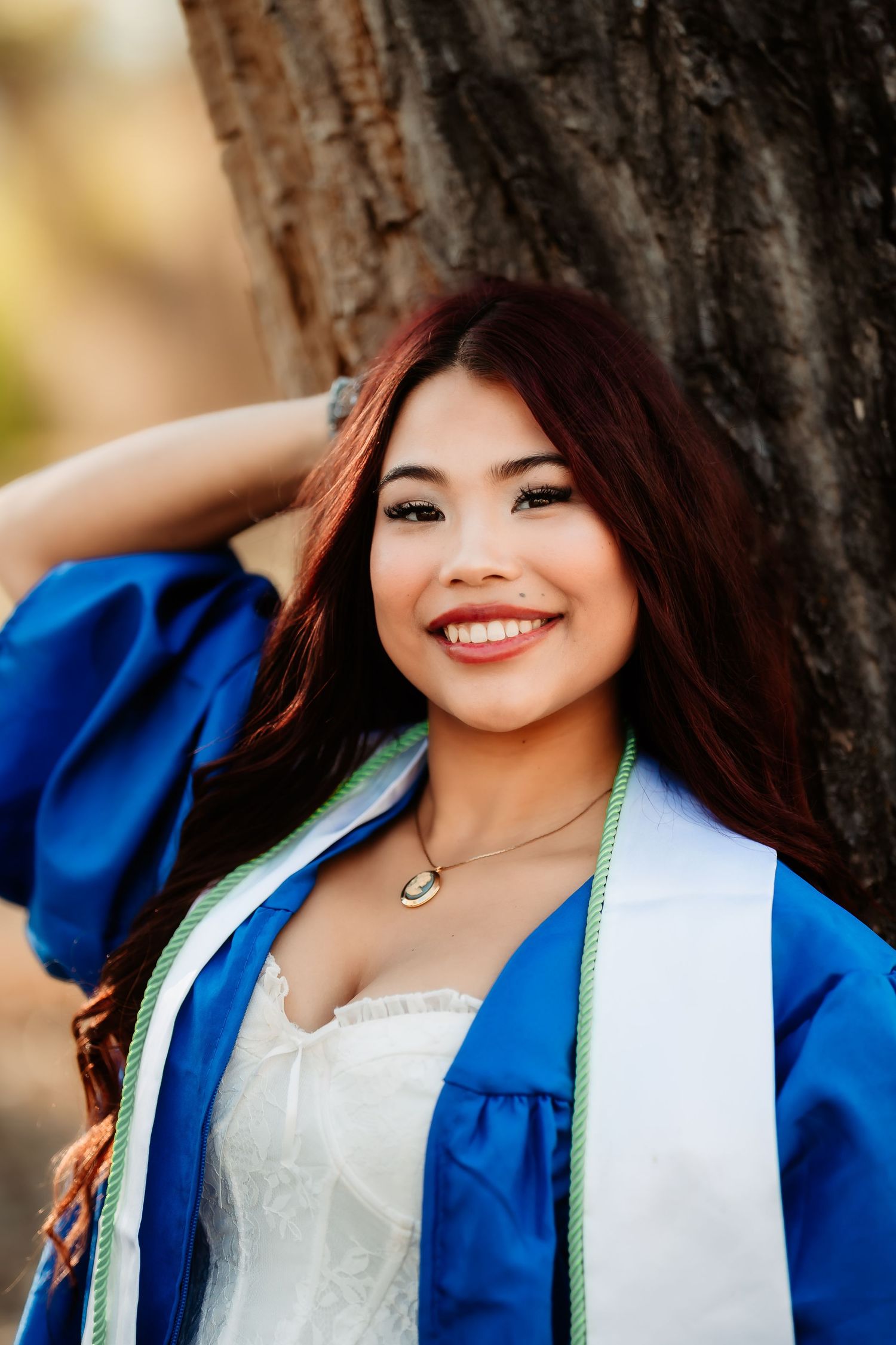 Close-up portrait shots showing bright blue attire and white accessories against a natural background.