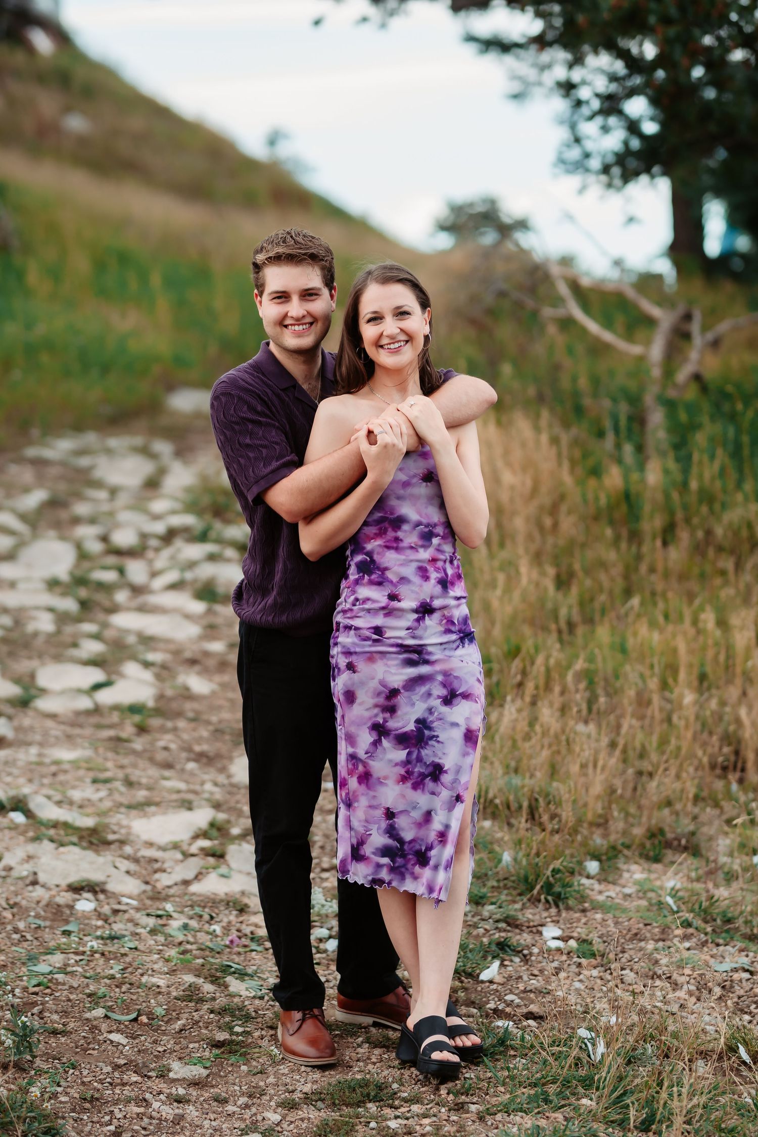 A playful sequence of romantic poses on a mountain path.